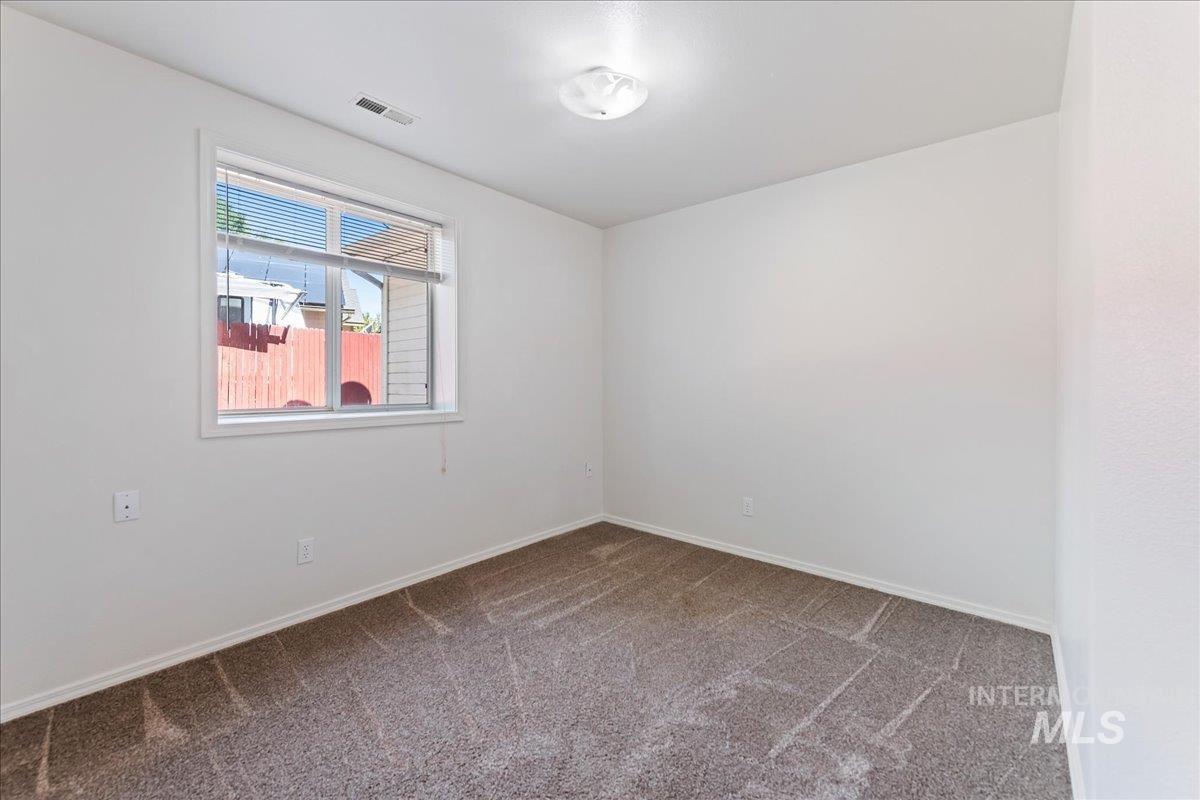Unfurnished room featuring carpet and baseboards
