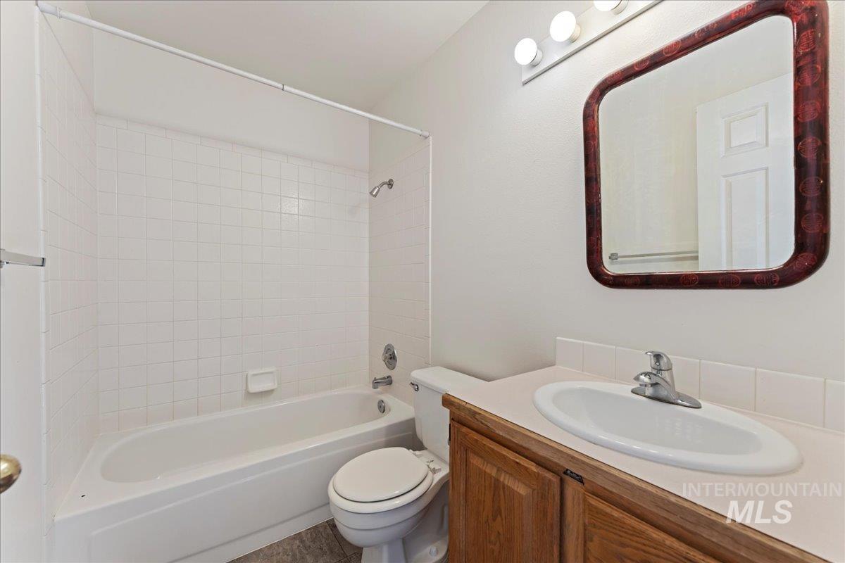 Full bath featuring shower / bathtub combination and vanity
