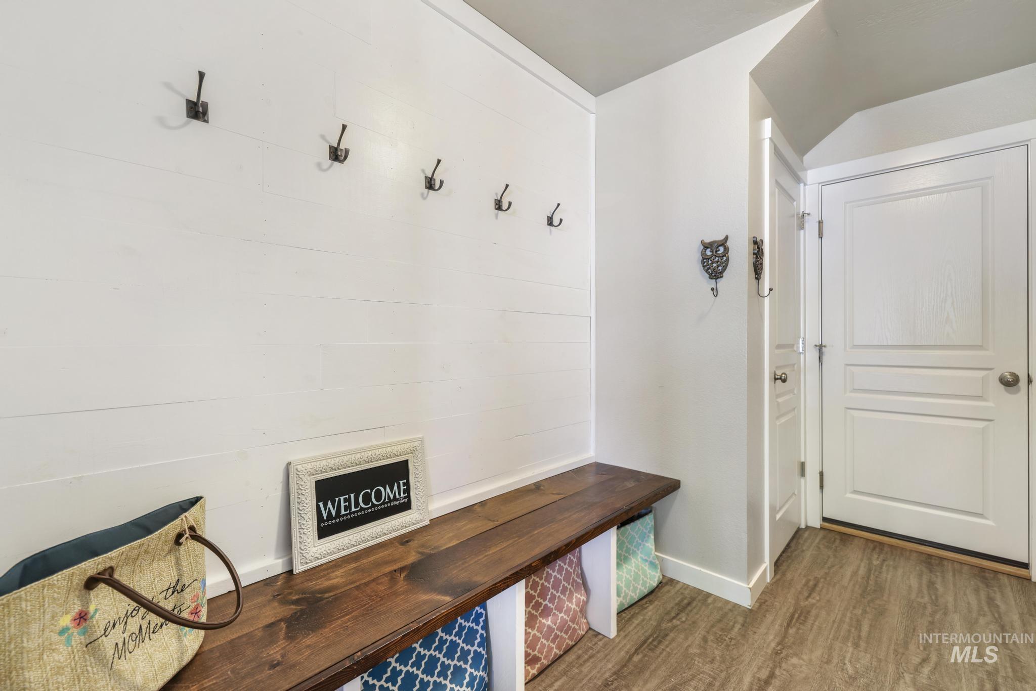 Mudroom with wood finished floors and baseboards