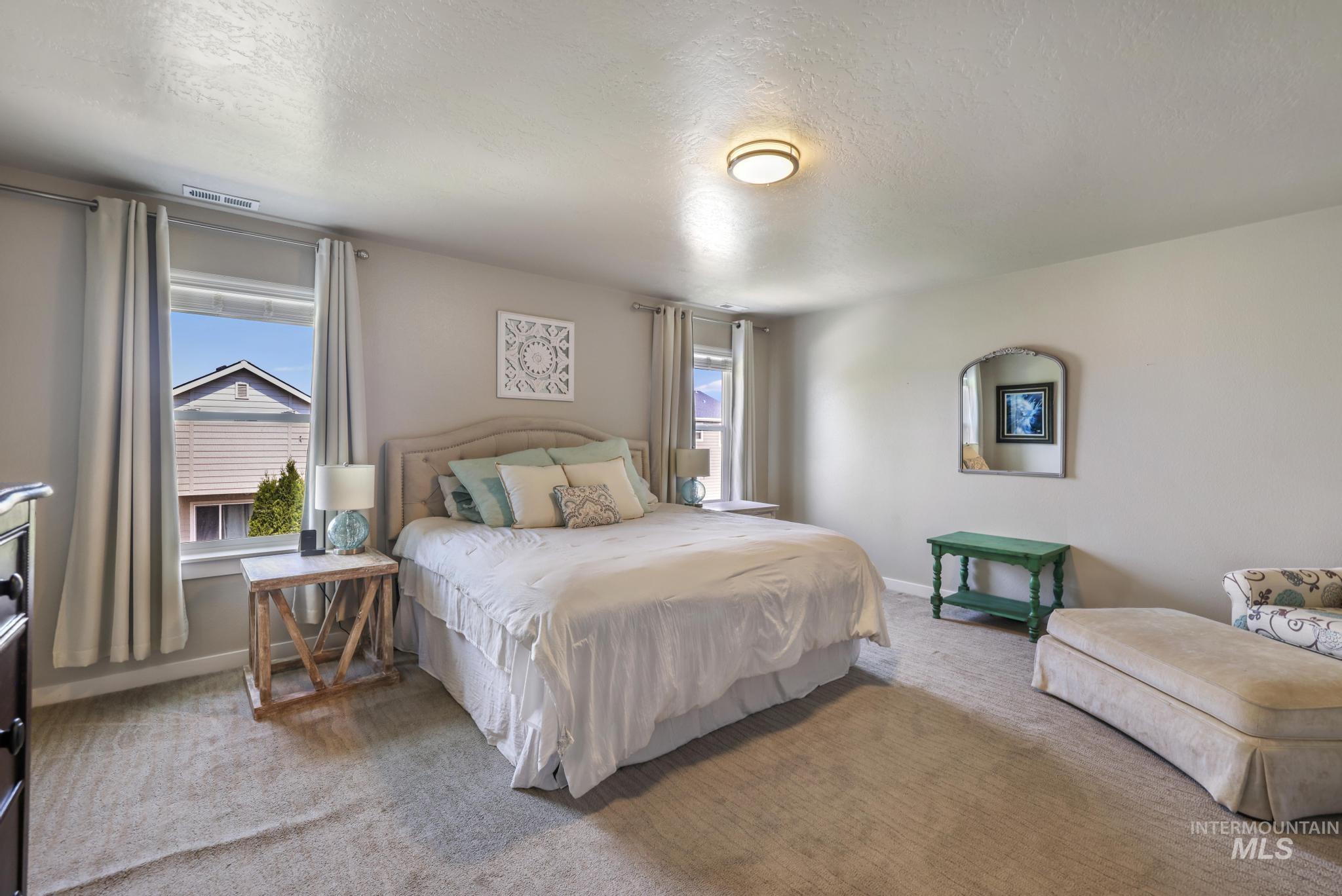 Bedroom with carpet flooring and a textured ceiling