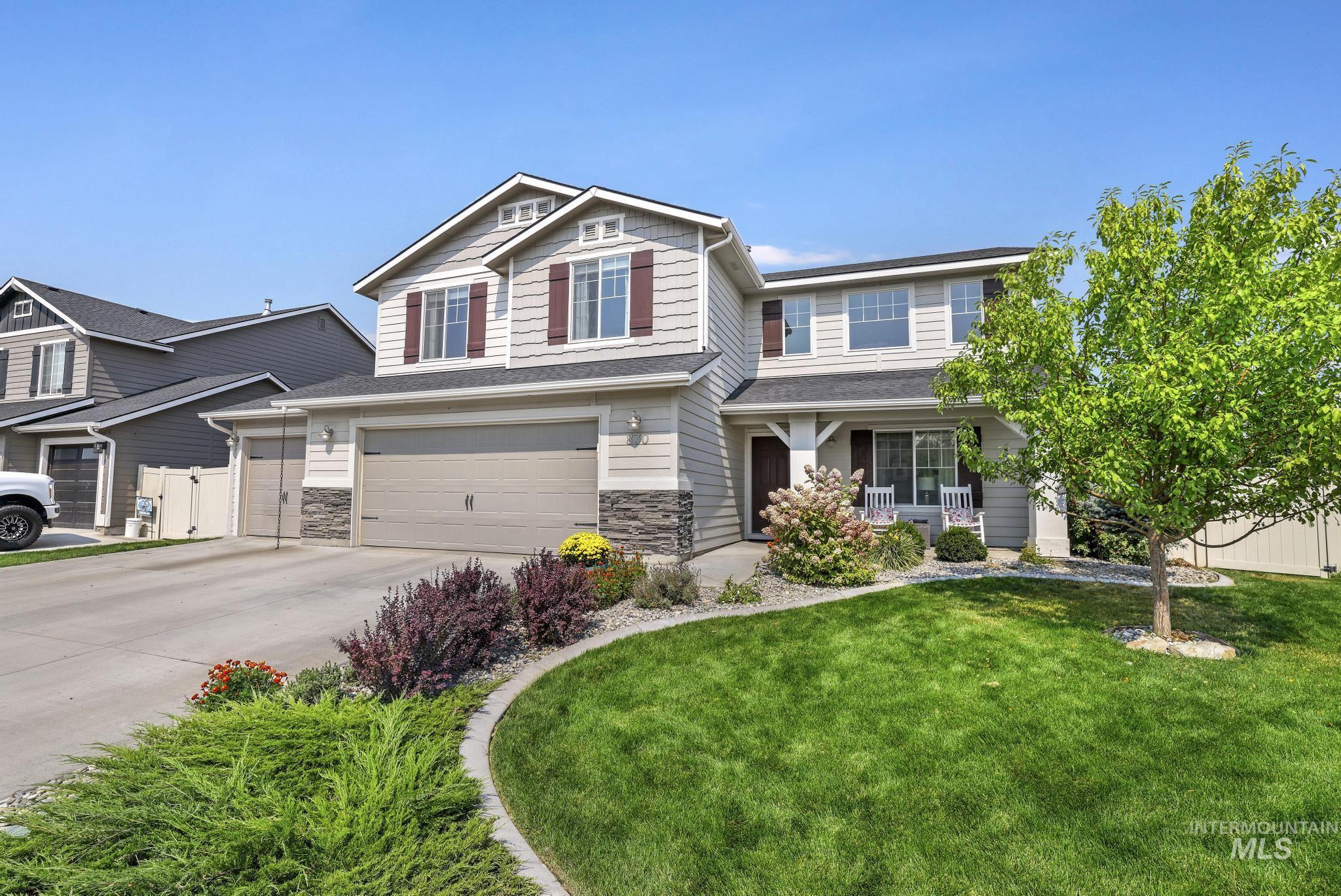 Craftsman-style home featuring covered porch, concrete driveway, an attached garage, stone siding, and roof with shingles