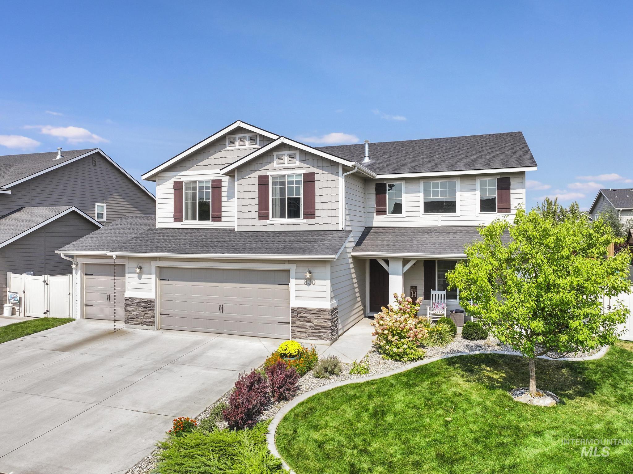 Craftsman-style home with roof with shingles, a porch, concrete driveway, and a front yard