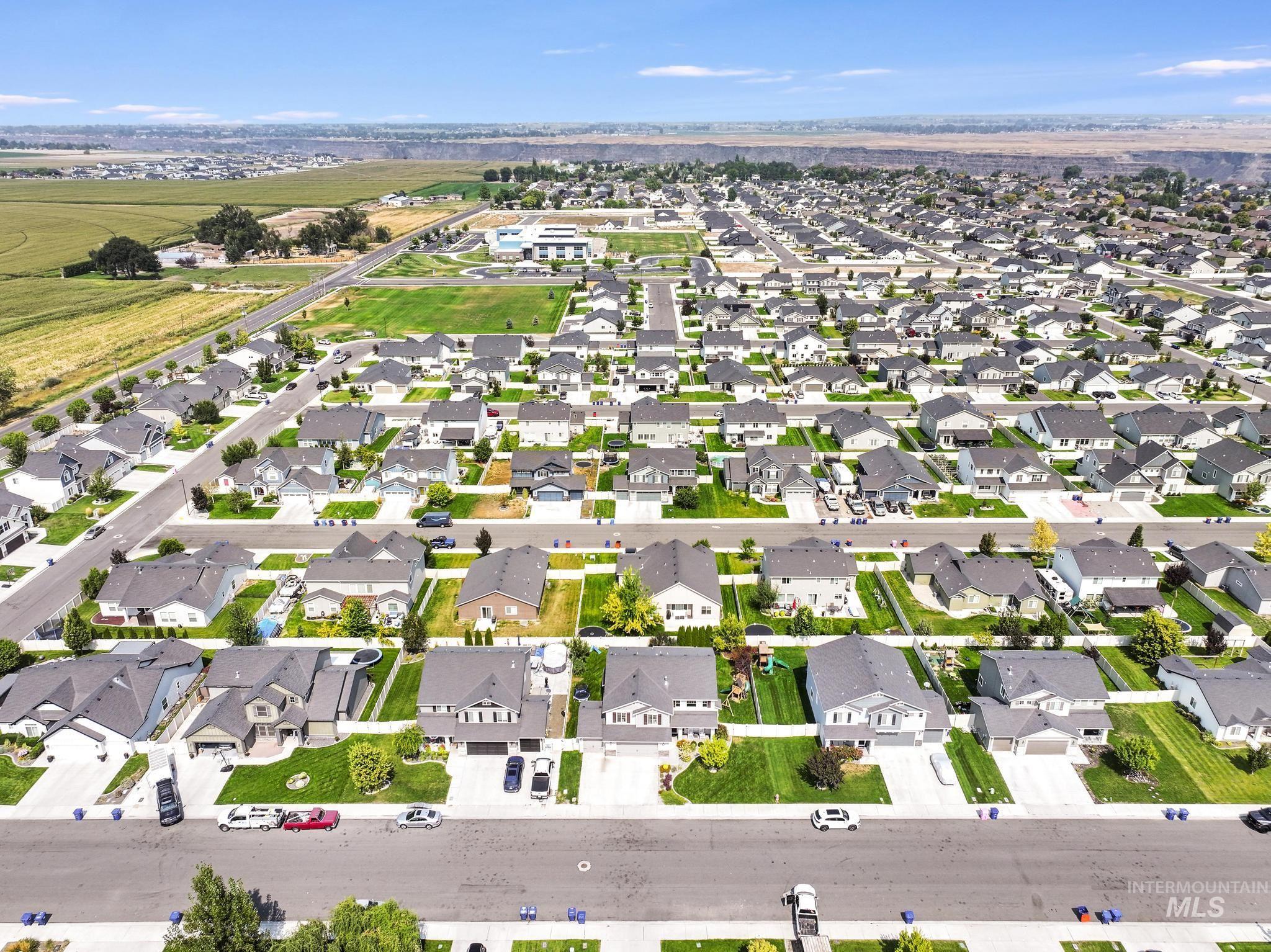 Aerial view of property's location featuring nearby suburban area