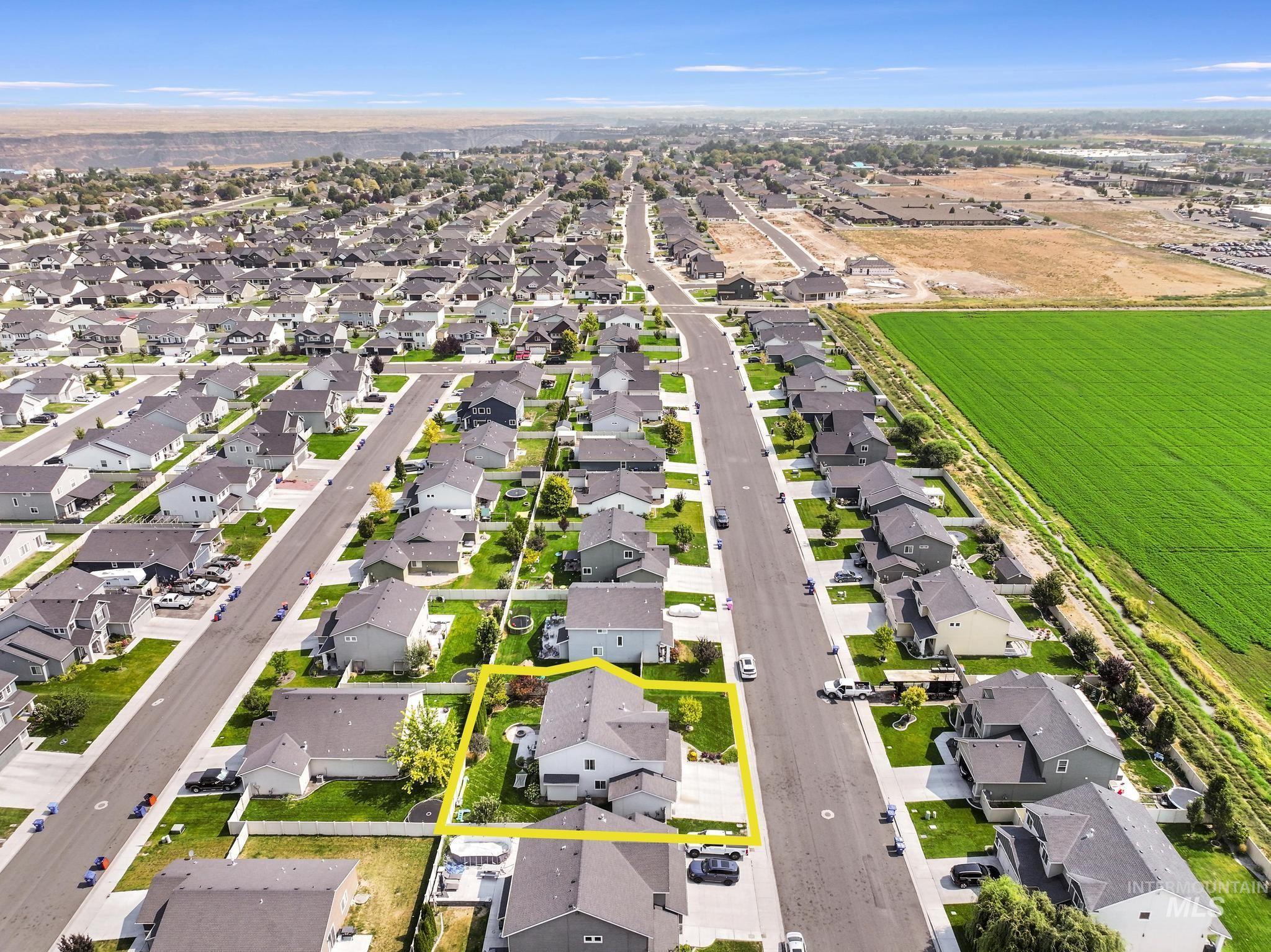 Aerial perspective of suburban area featuring property boundaries highlighted