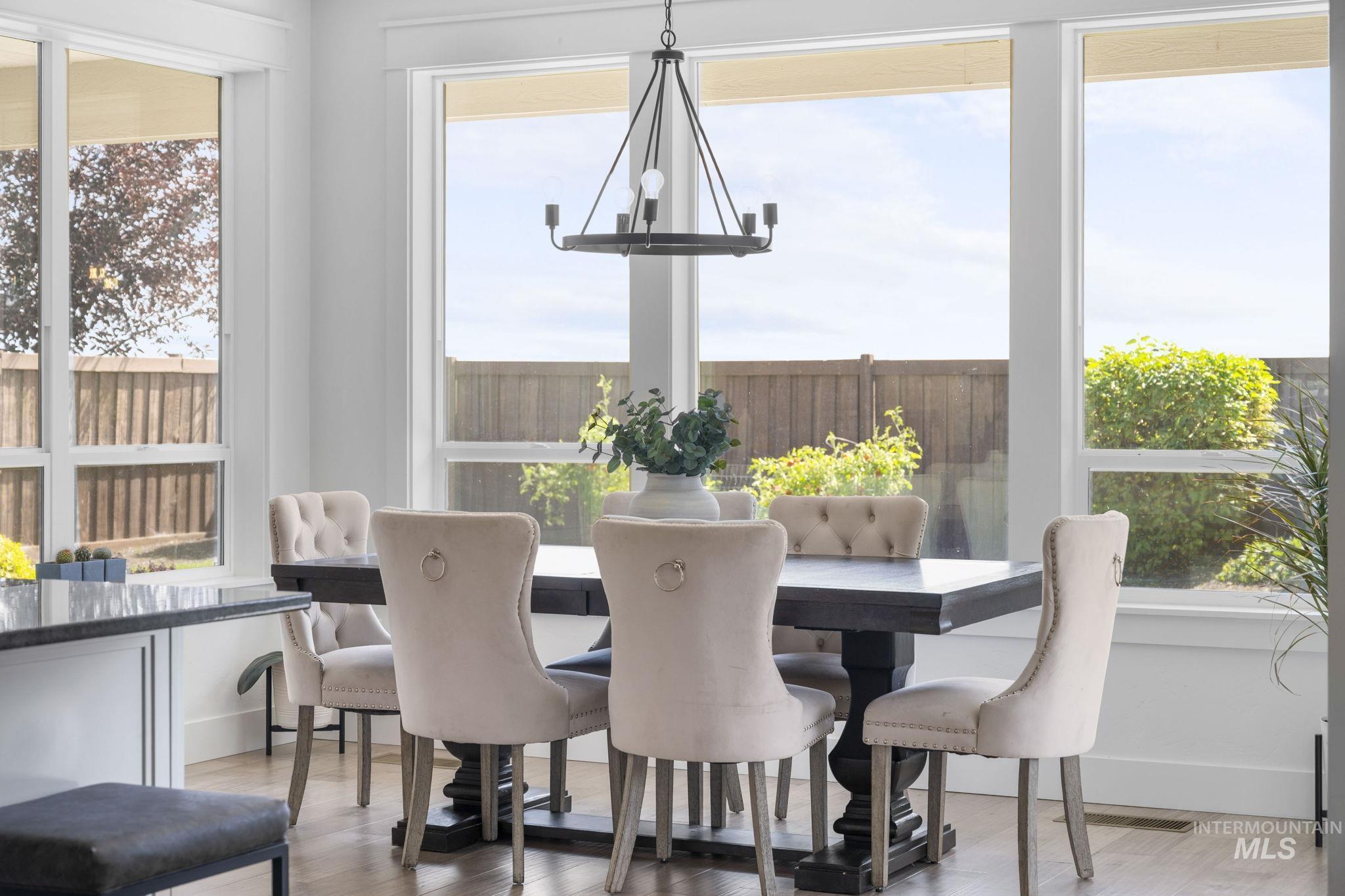 Dining area with a chandelier and wood finished floors