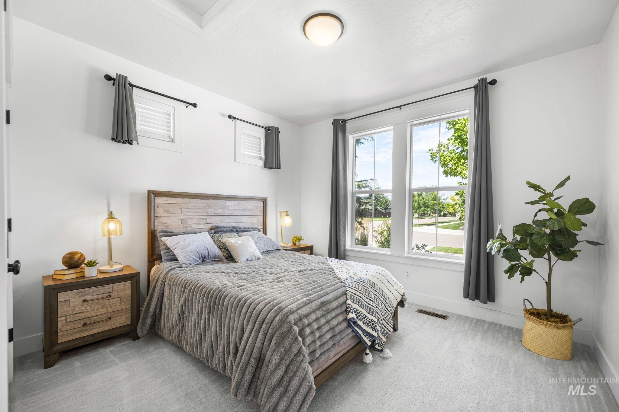 Main level, secondary bedroom featuring carpet floors and baseboards