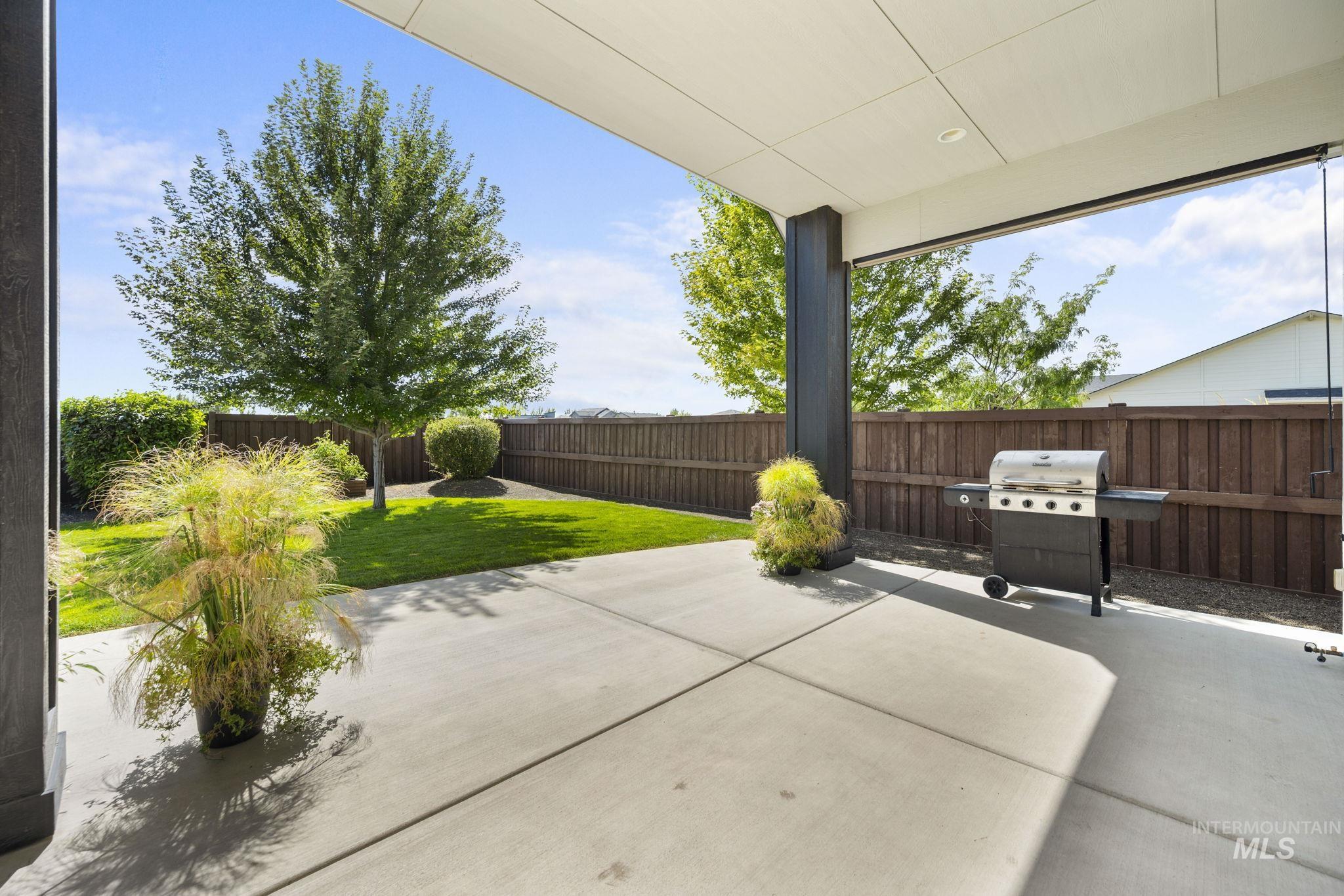 Fenced backyard with a covered patio