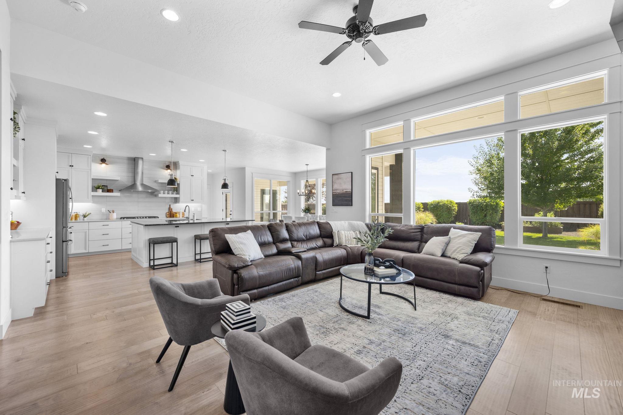 Living room featuring recessed lighting, ceiling fan, and light wood-style floors