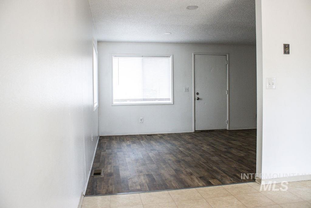 Spare room featuring a textured ceiling and light wood-type flooring