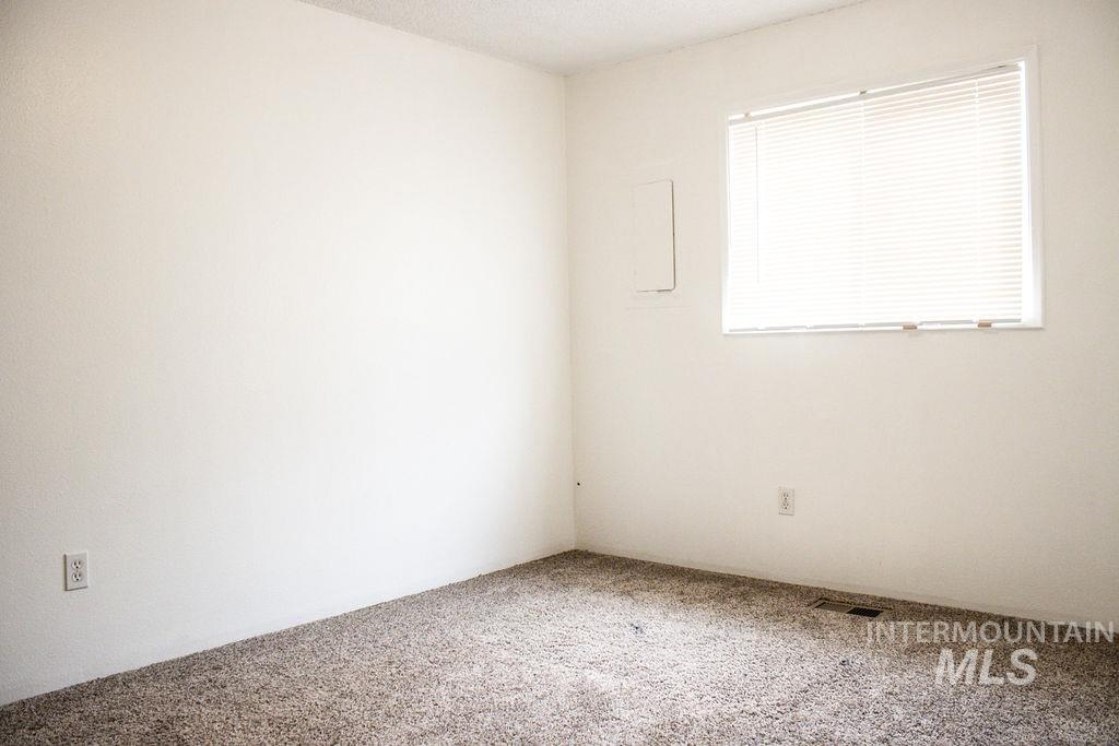 Carpeted spare room with a textured ceiling
