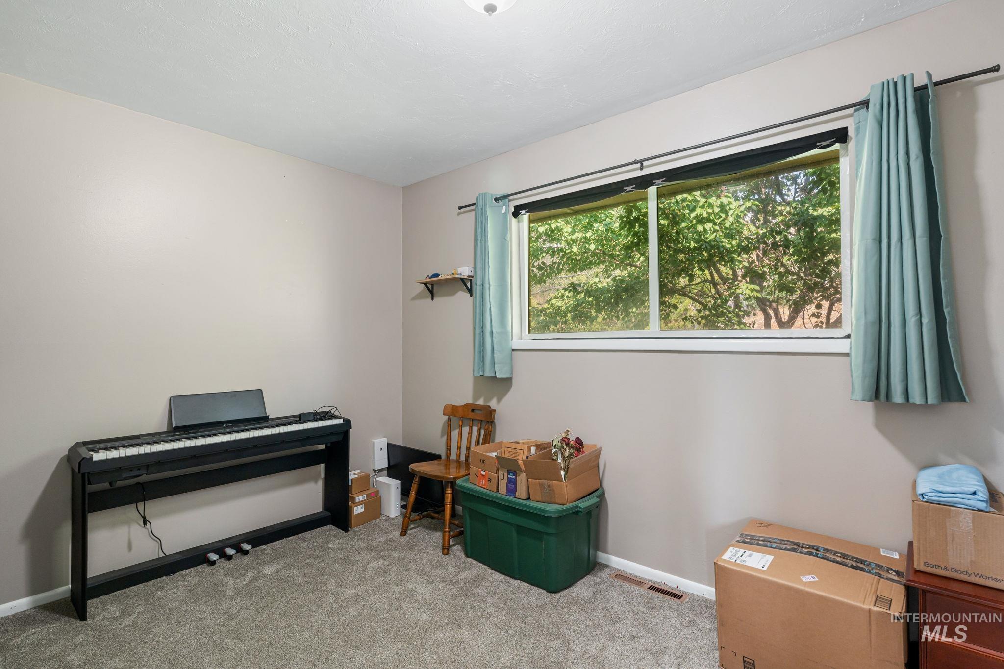 Misc room with carpet and baseboards