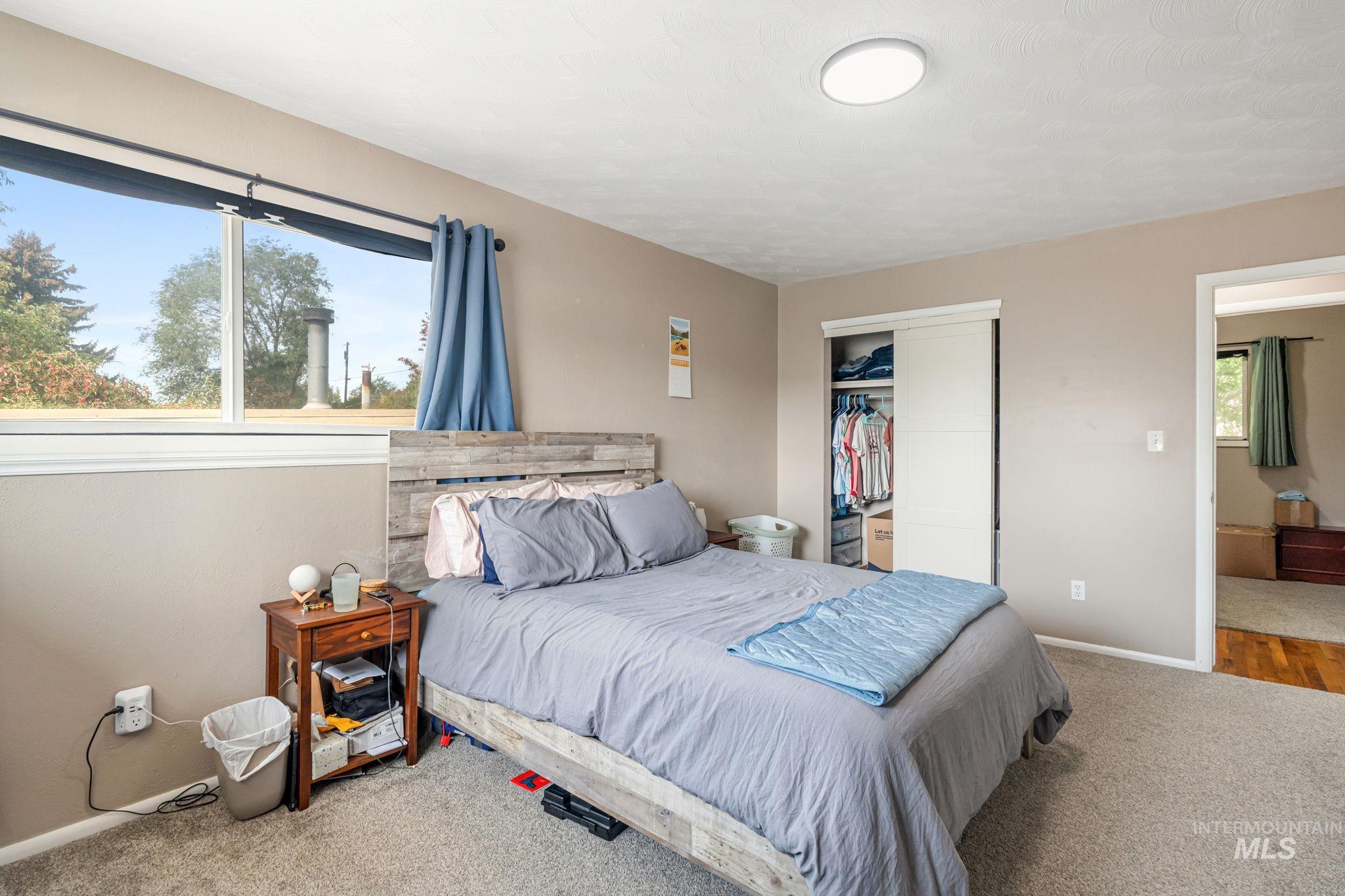 Bedroom featuring carpet and a closet