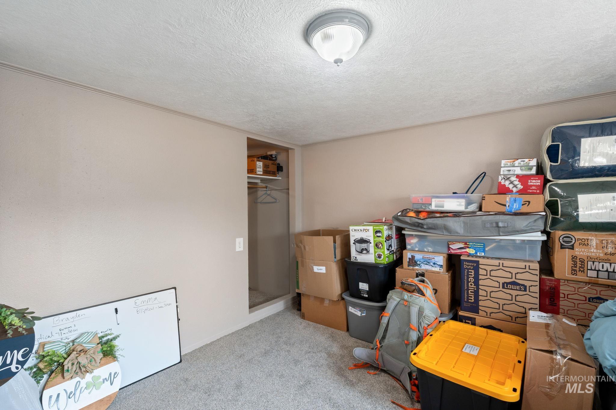 Office area with a textured ceiling and light carpet