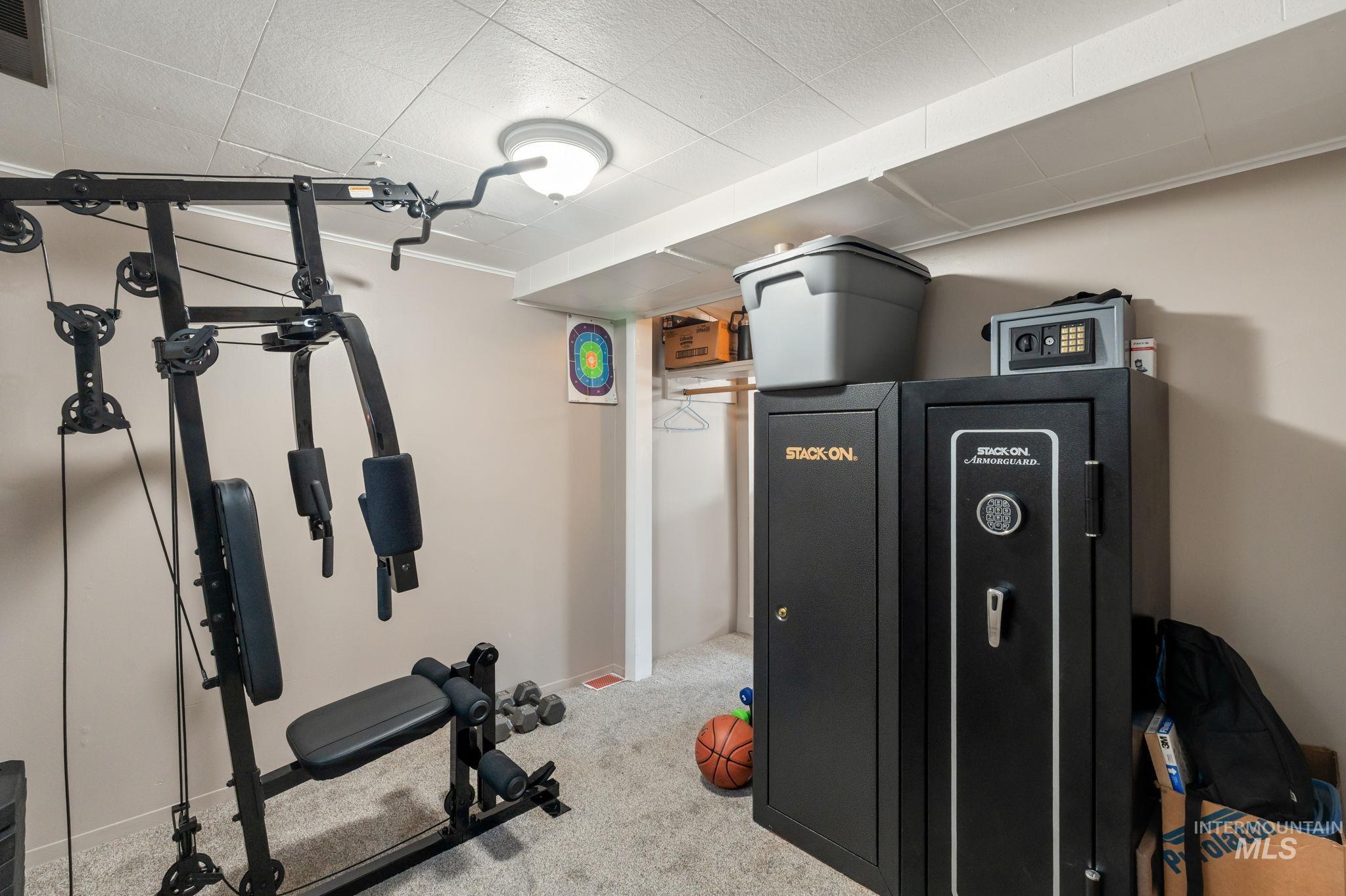 Workout area featuring carpet and baseboards