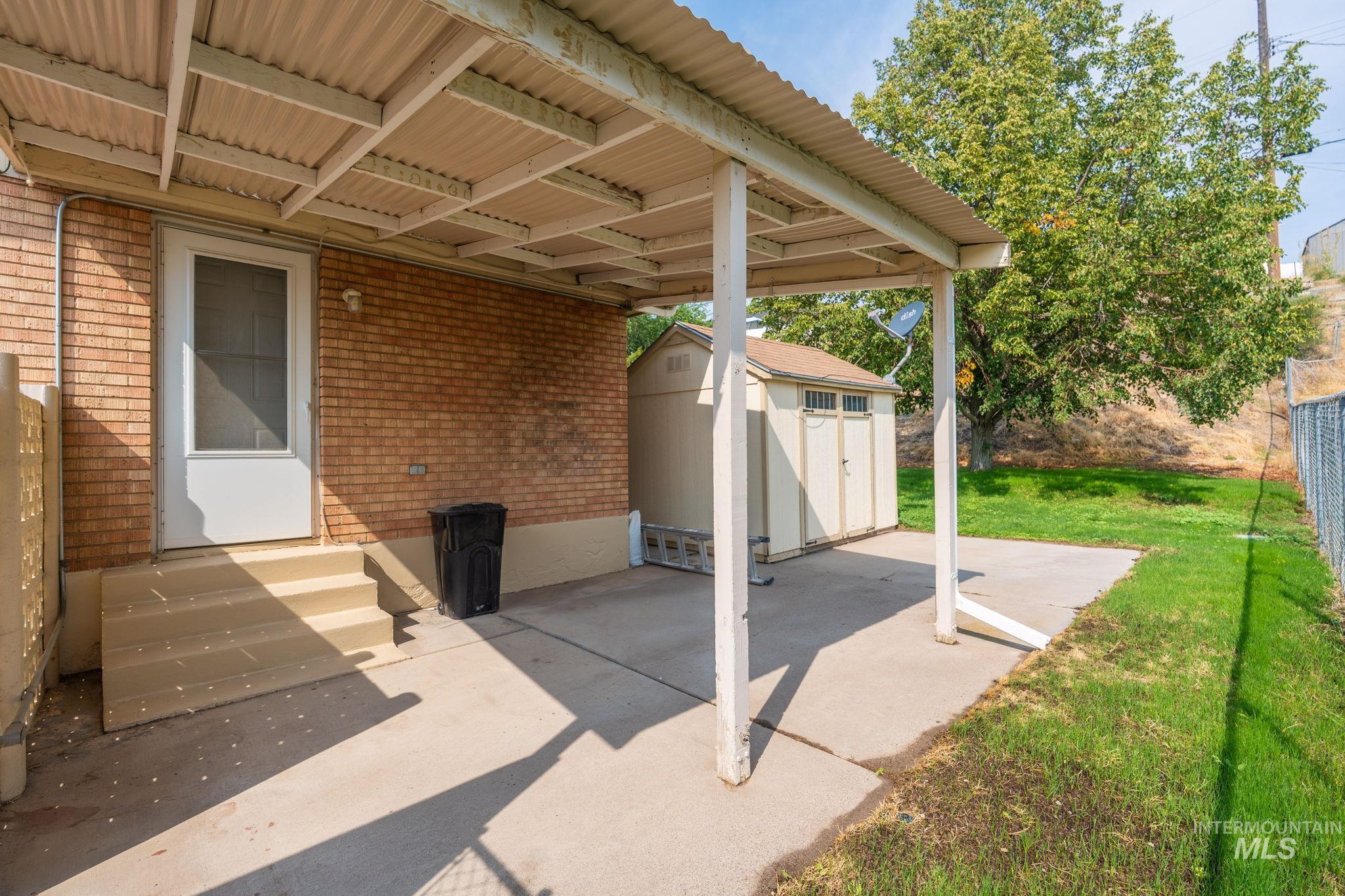 View of patio / terrace featuring a storage unit and entry steps