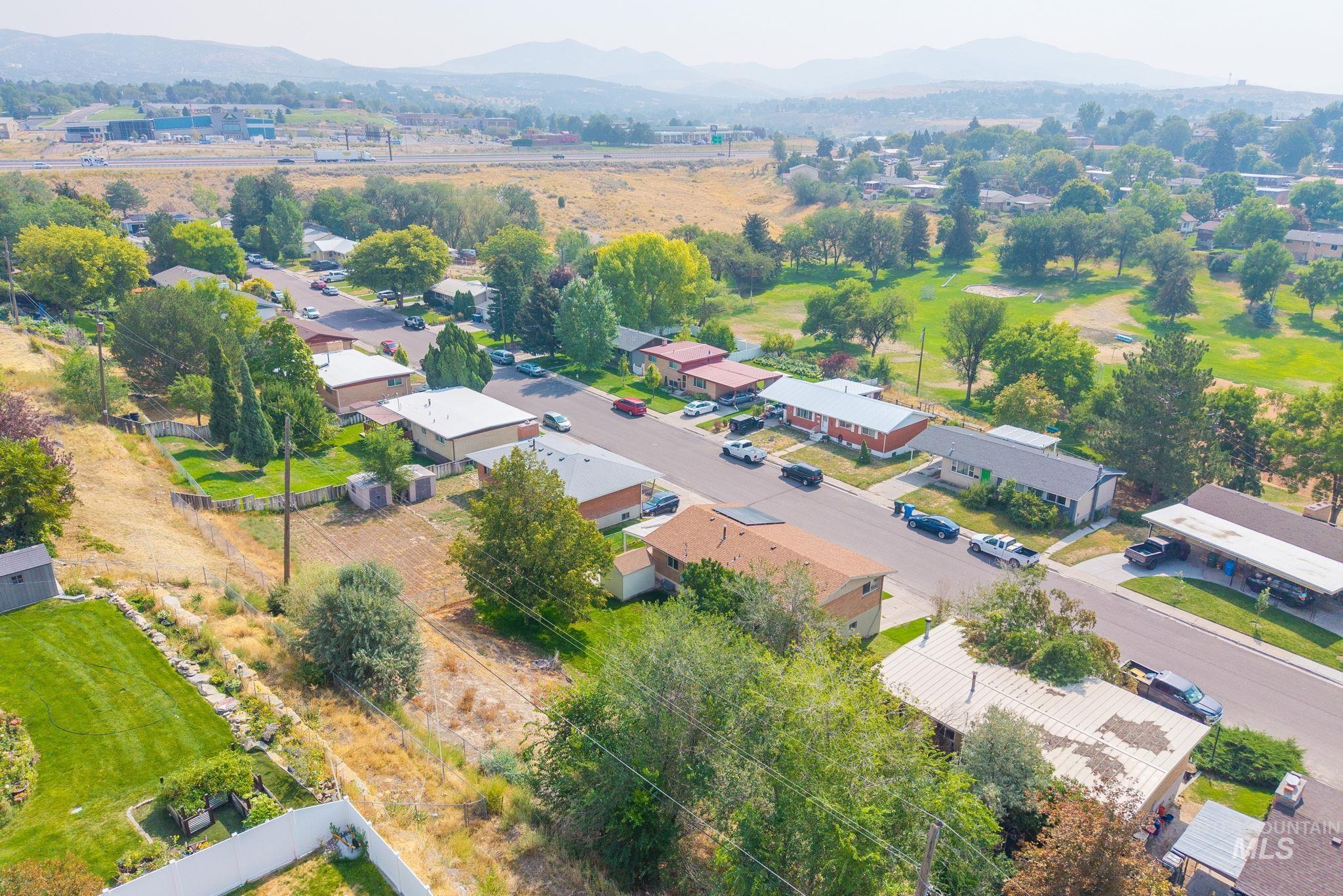 Aerial perspective of suburban area featuring a mountainous background