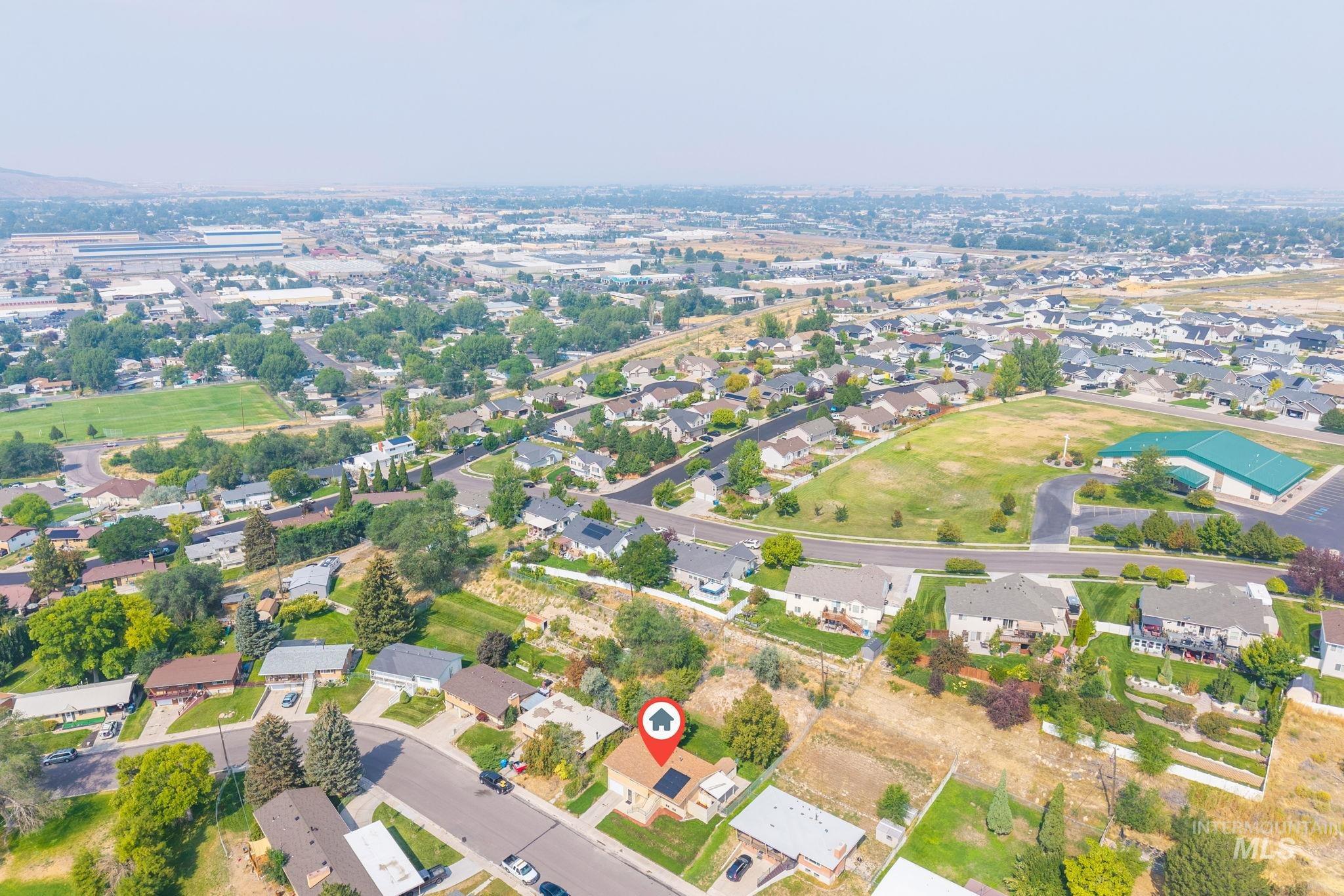 Aerial overview of property's location with nearby suburban area