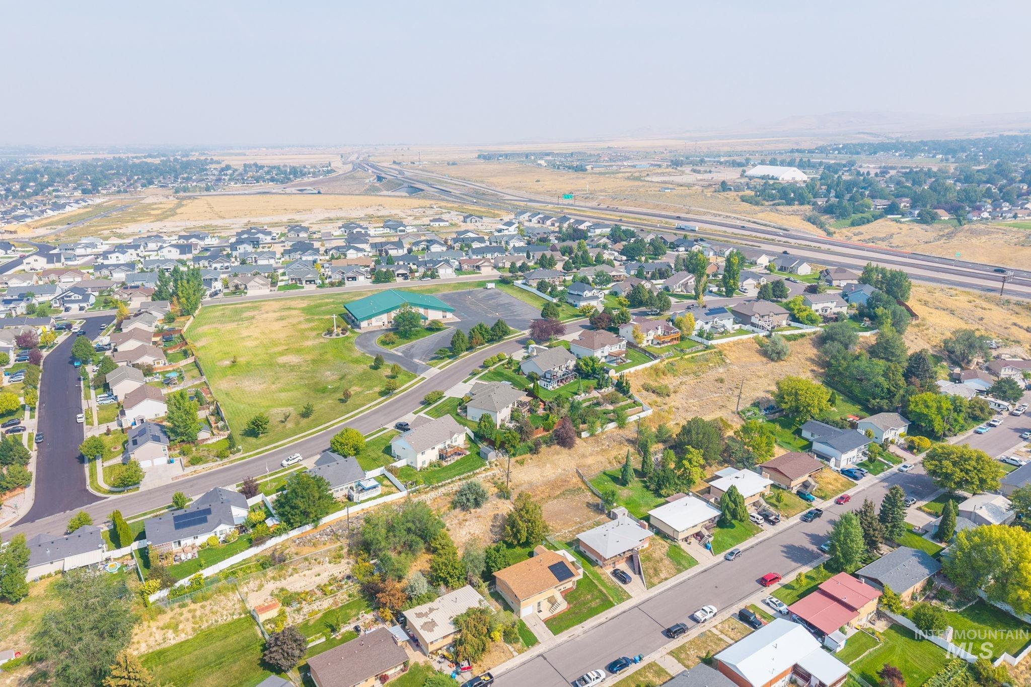 Aerial view of property's location with nearby suburban area