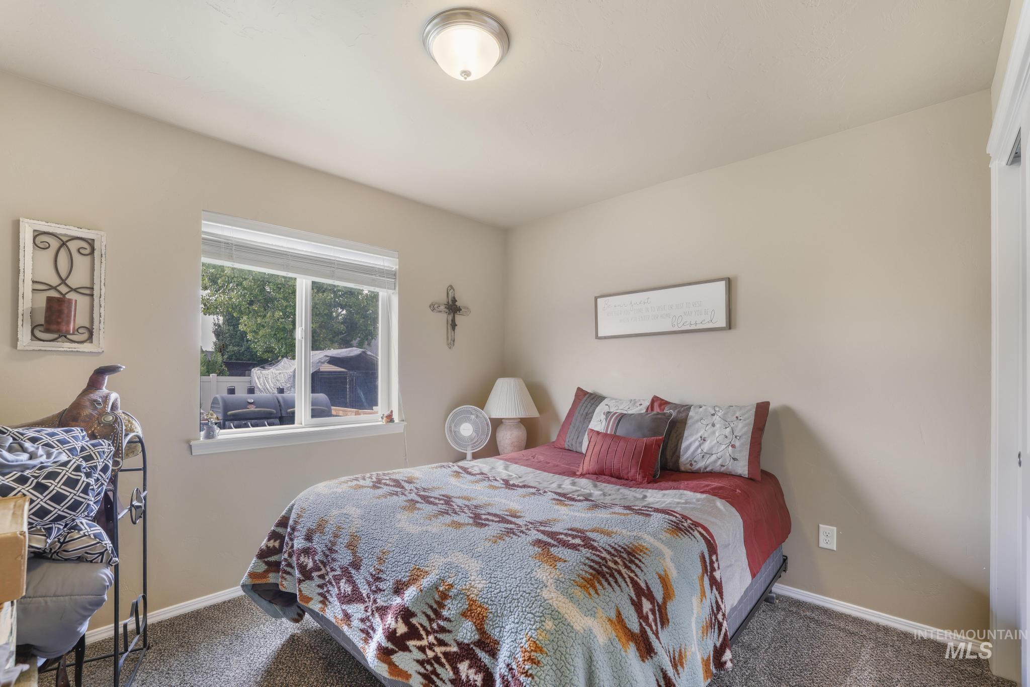 Bedroom with carpet flooring and baseboards