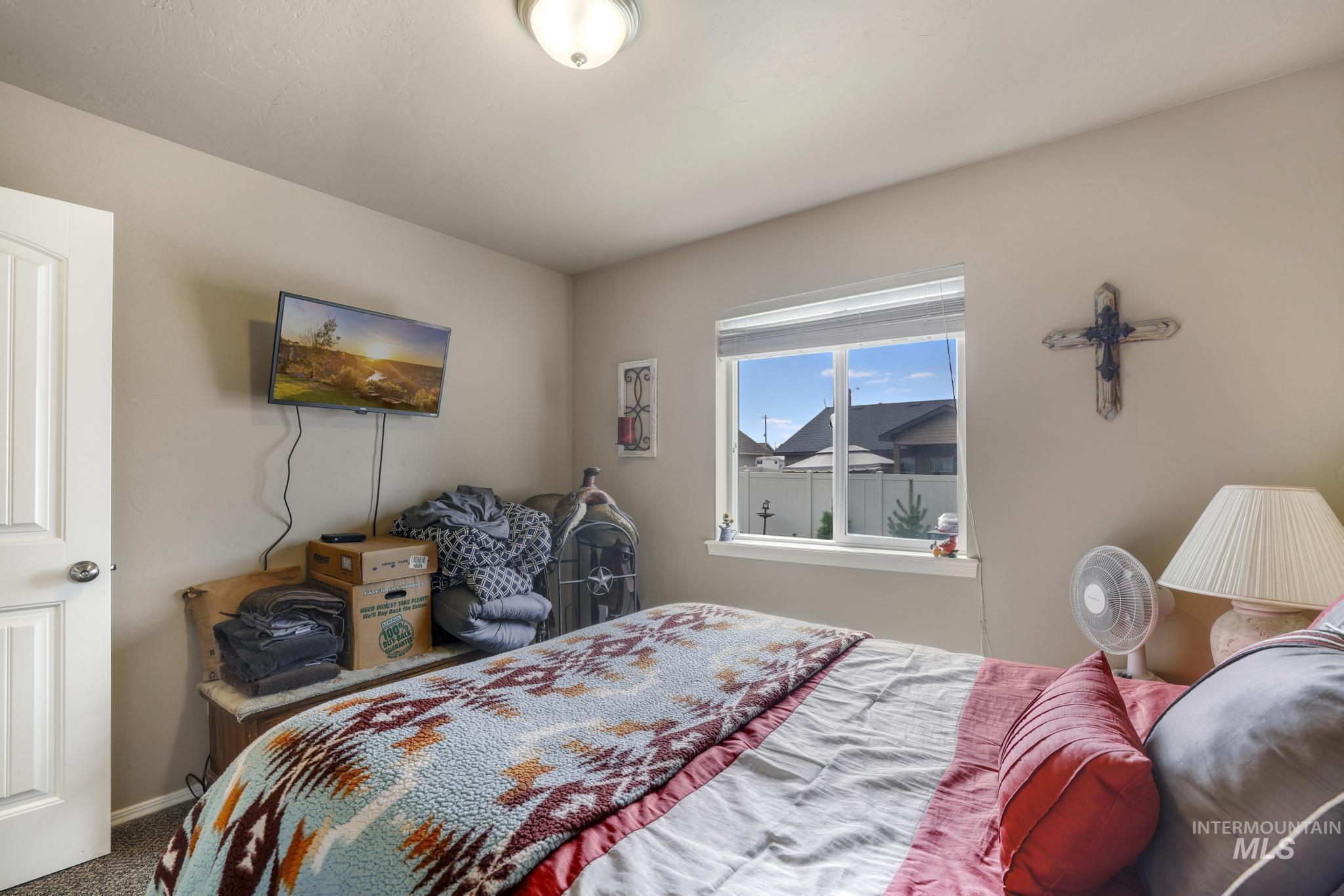 Carpeted bedroom featuring baseboards