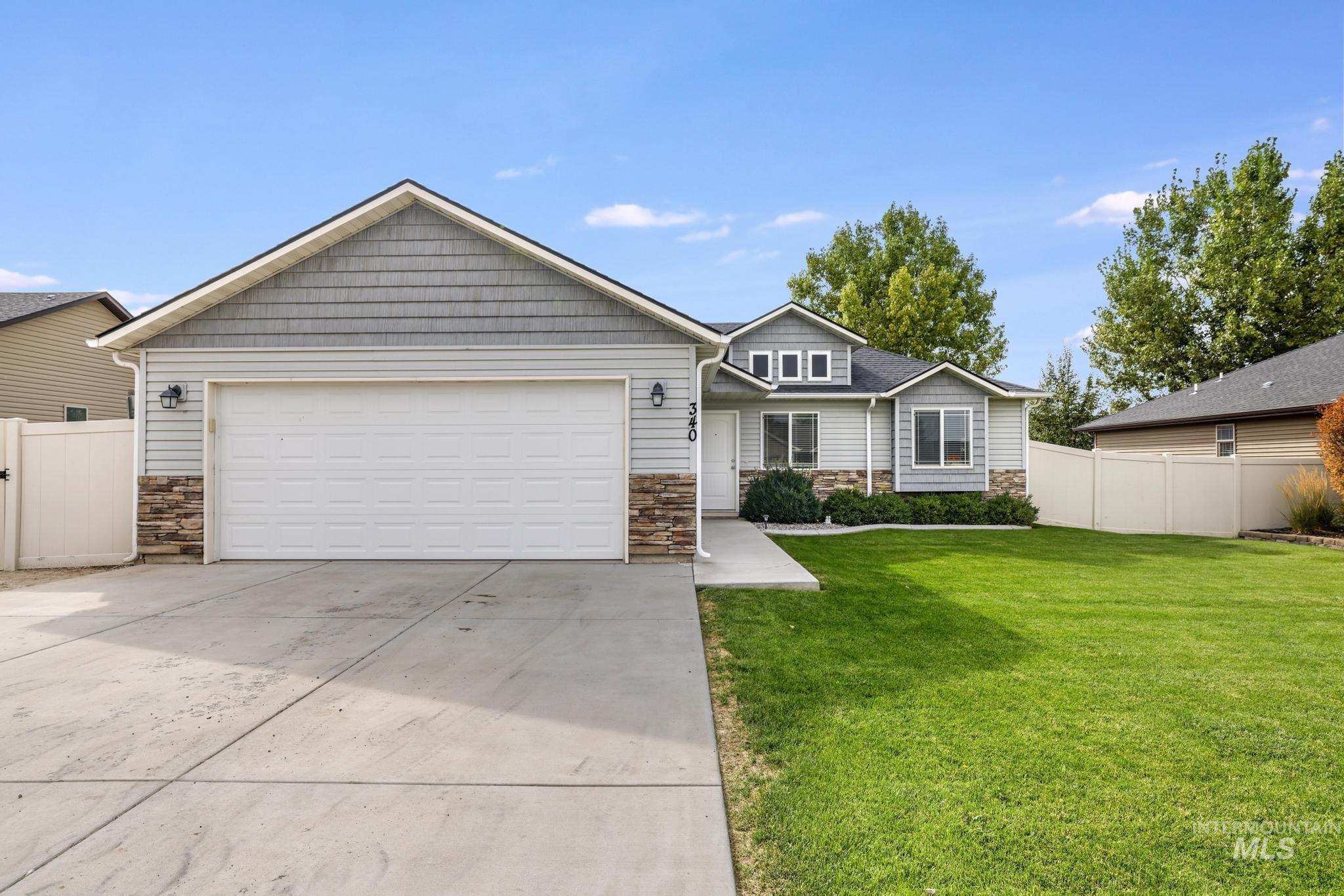 Craftsman house with stone siding, concrete driveway, and an attached garage