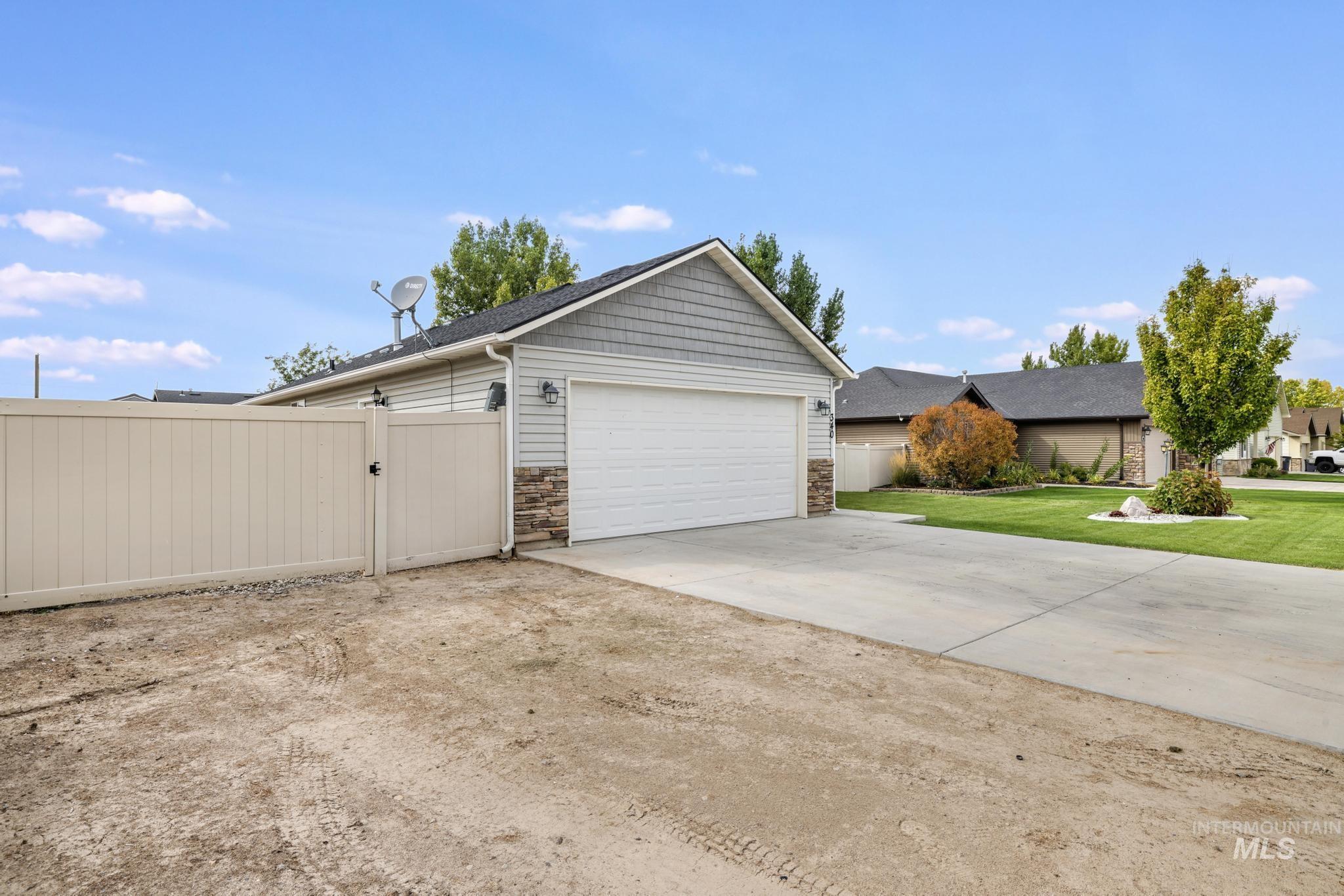 Garage featuring a gate and driveway