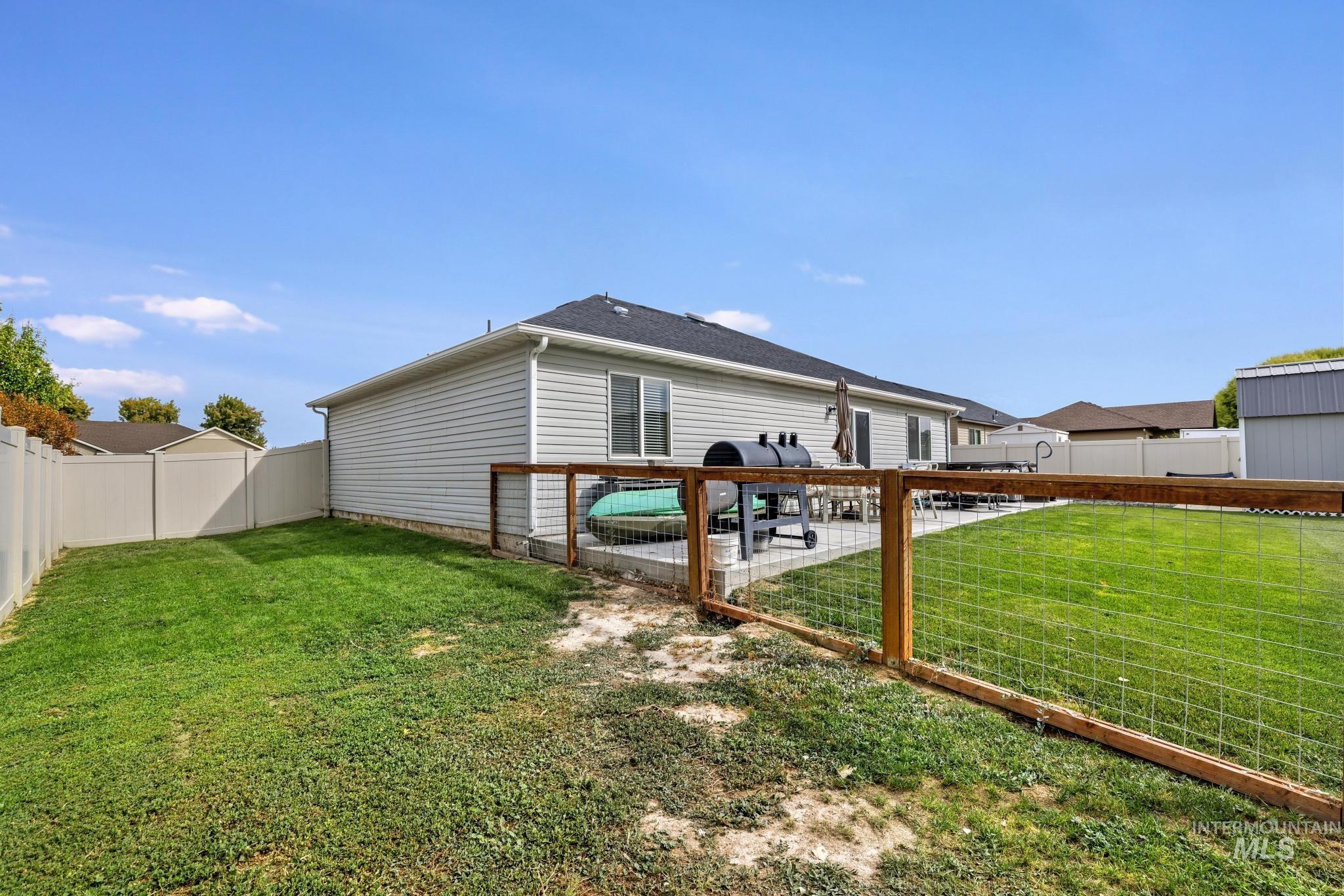 Rear view of property with a patio area and a fenced backyard