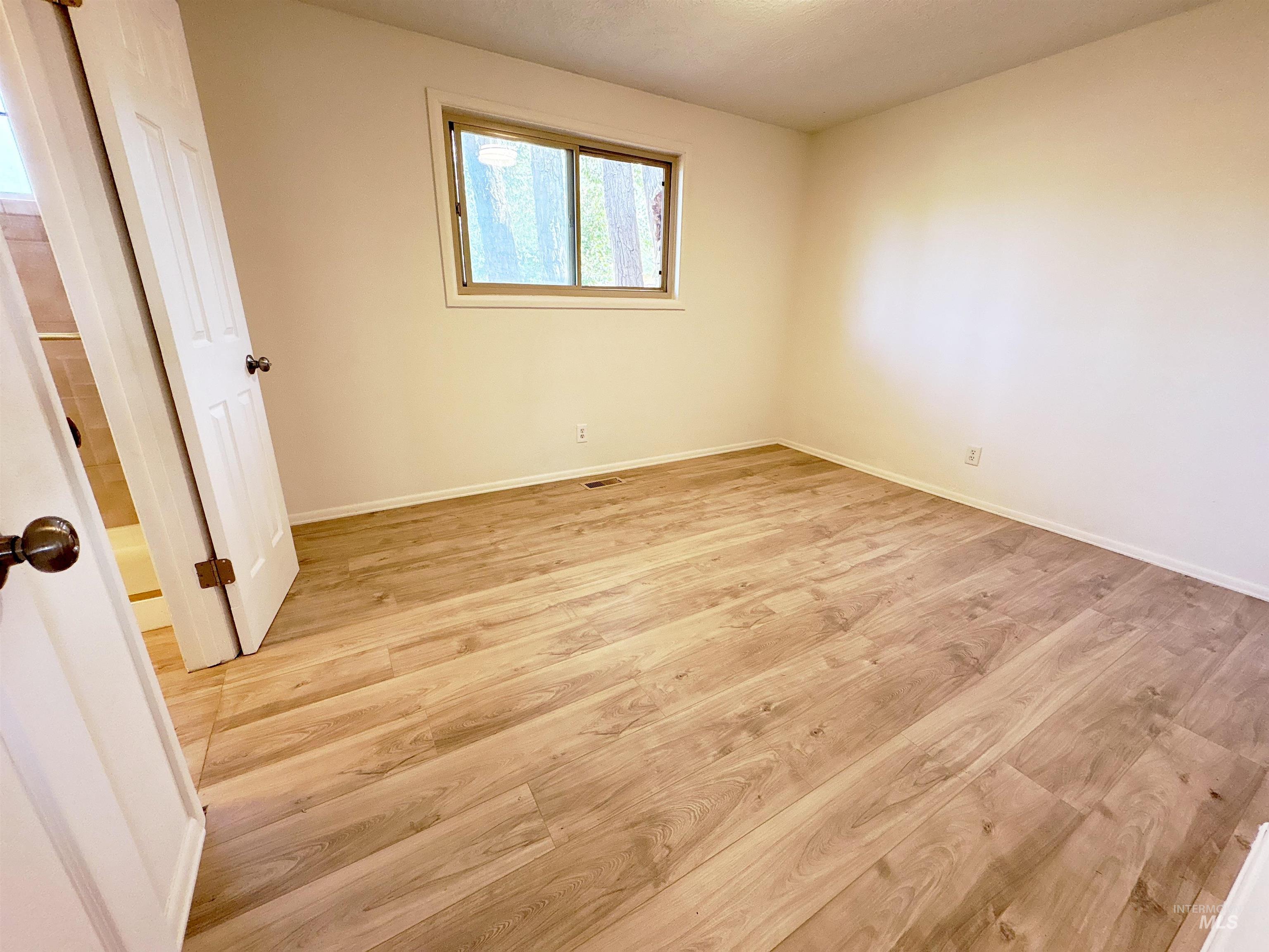 Unfurnished bedroom with light wood-style floors