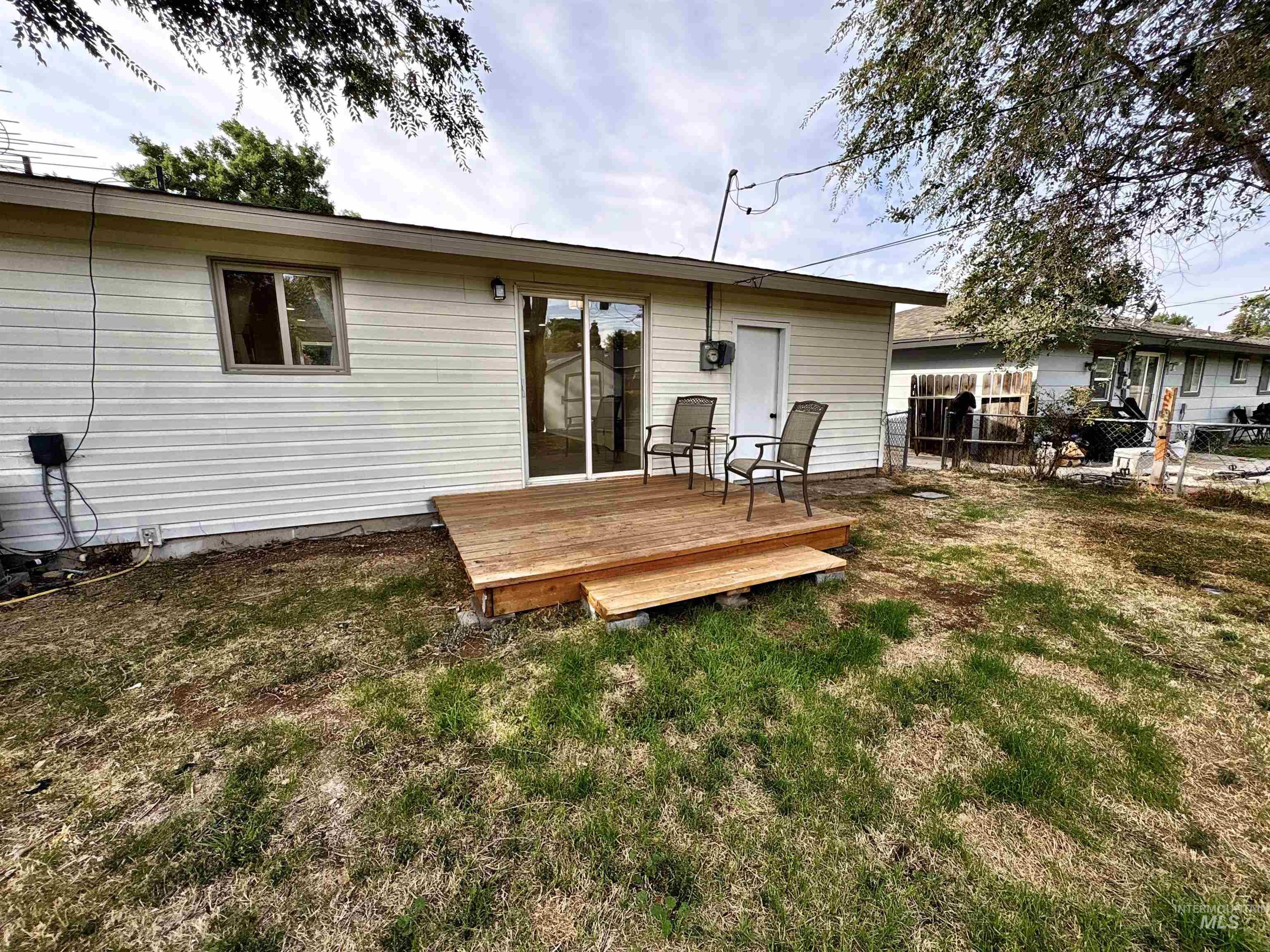 Rear view of house featuring a wooden deck