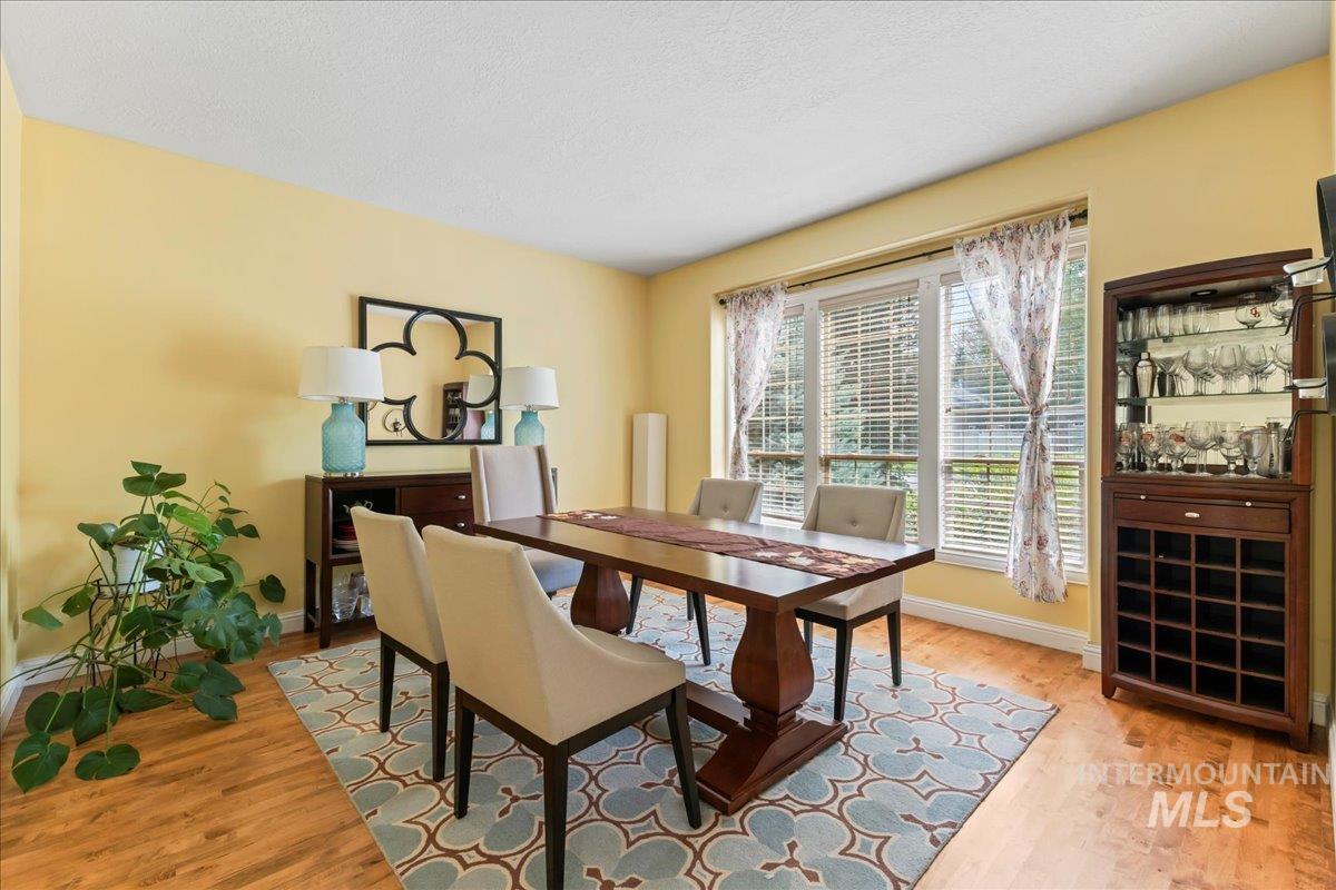 Dining space with light wood-style floors and a textured ceiling