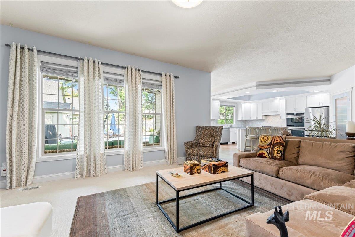 Living room featuring light carpet and baseboards