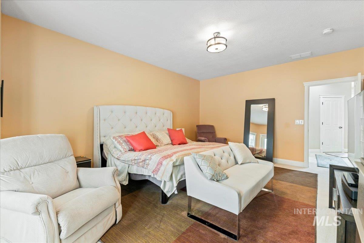 Carpeted bedroom featuring baseboards