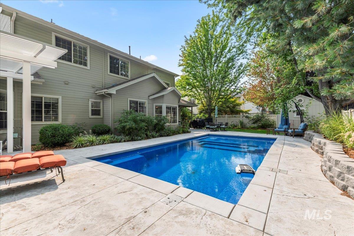 View of swimming pool featuring a shed and a patio area