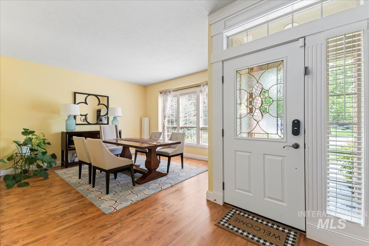 Foyer entrance featuring light wood-type flooring and baseboards