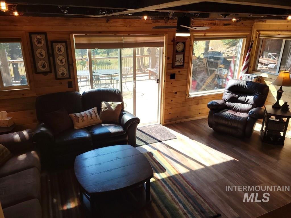 Living area featuring wood walls and wood finished floors