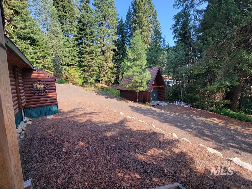 View of yard featuring an outdoor structure and a forest view