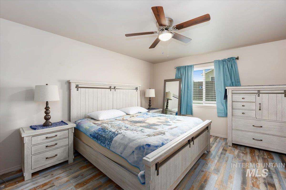 Bedroom featuring wood finished floors and ceiling fan