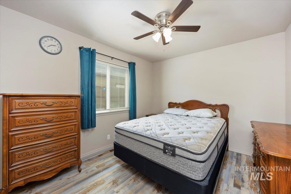 Bedroom with wood finished floors and ceiling fan