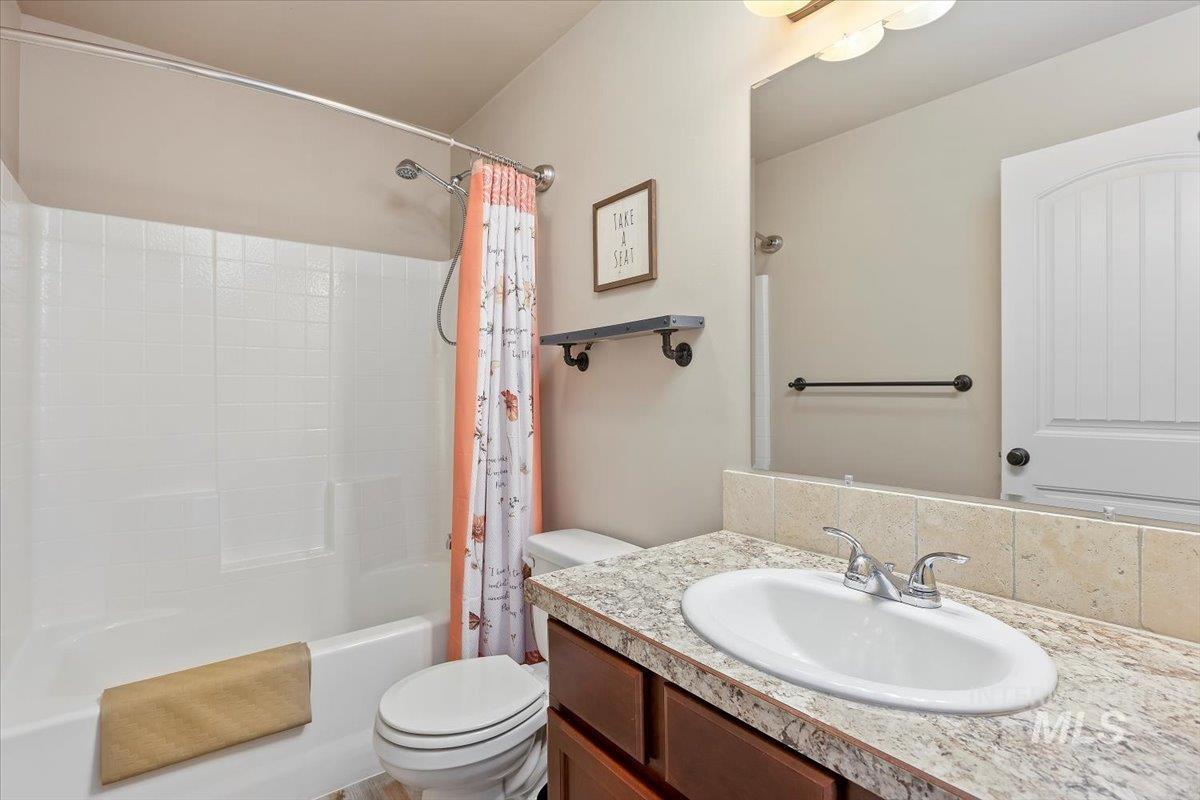 Full bath featuring shower / tub combo and vanity