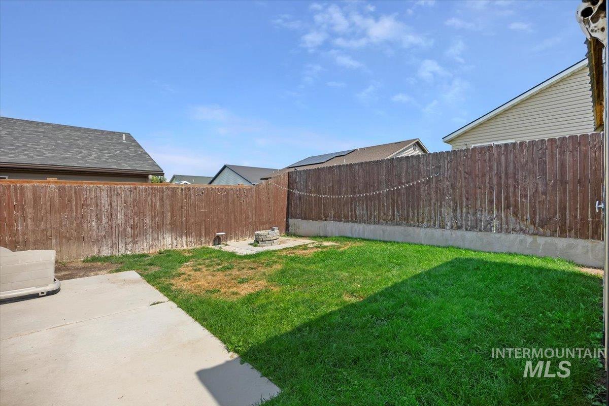 Fenced backyard featuring a patio
