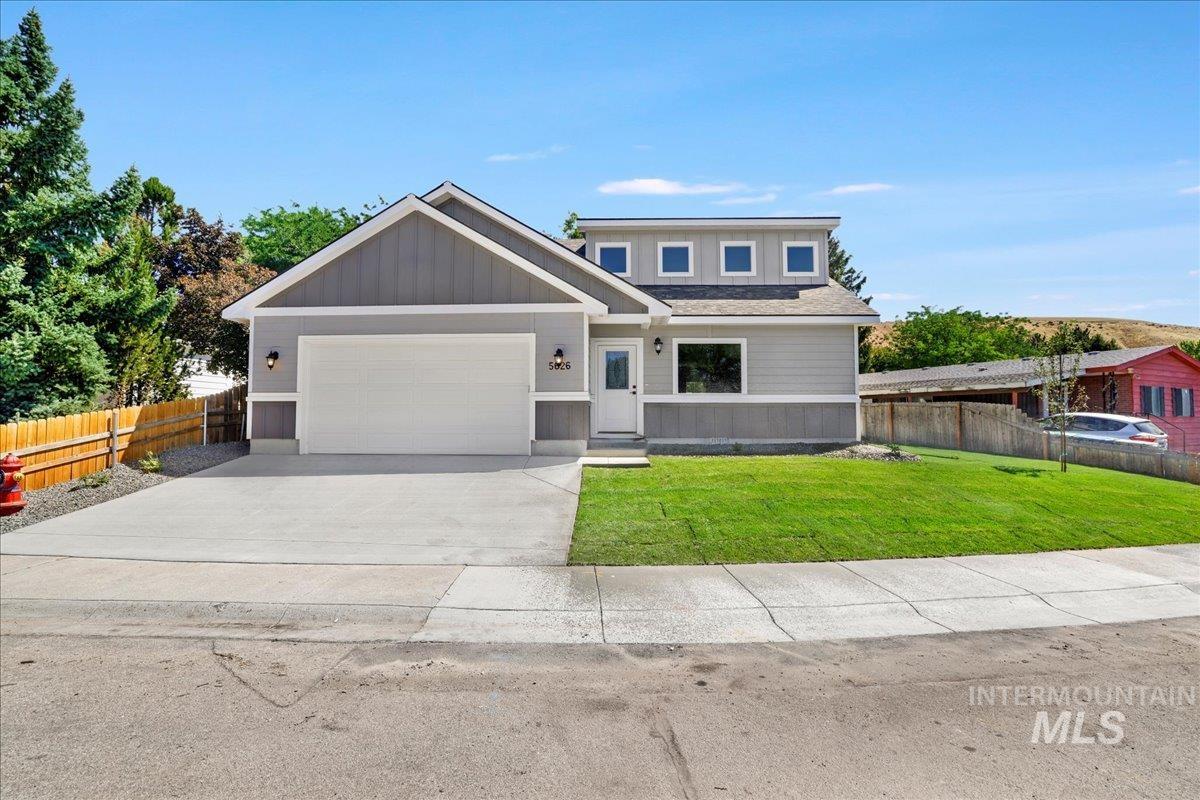 View of front of property with concrete driveway, a garage, and board and batten siding