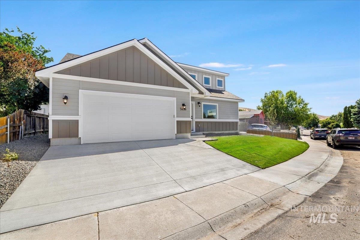 View of front of house featuring concrete driveway, a garage, and board and batten siding