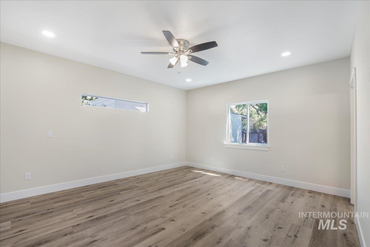 Spare room featuring light wood-type flooring, recessed lighting, and a ceiling fan