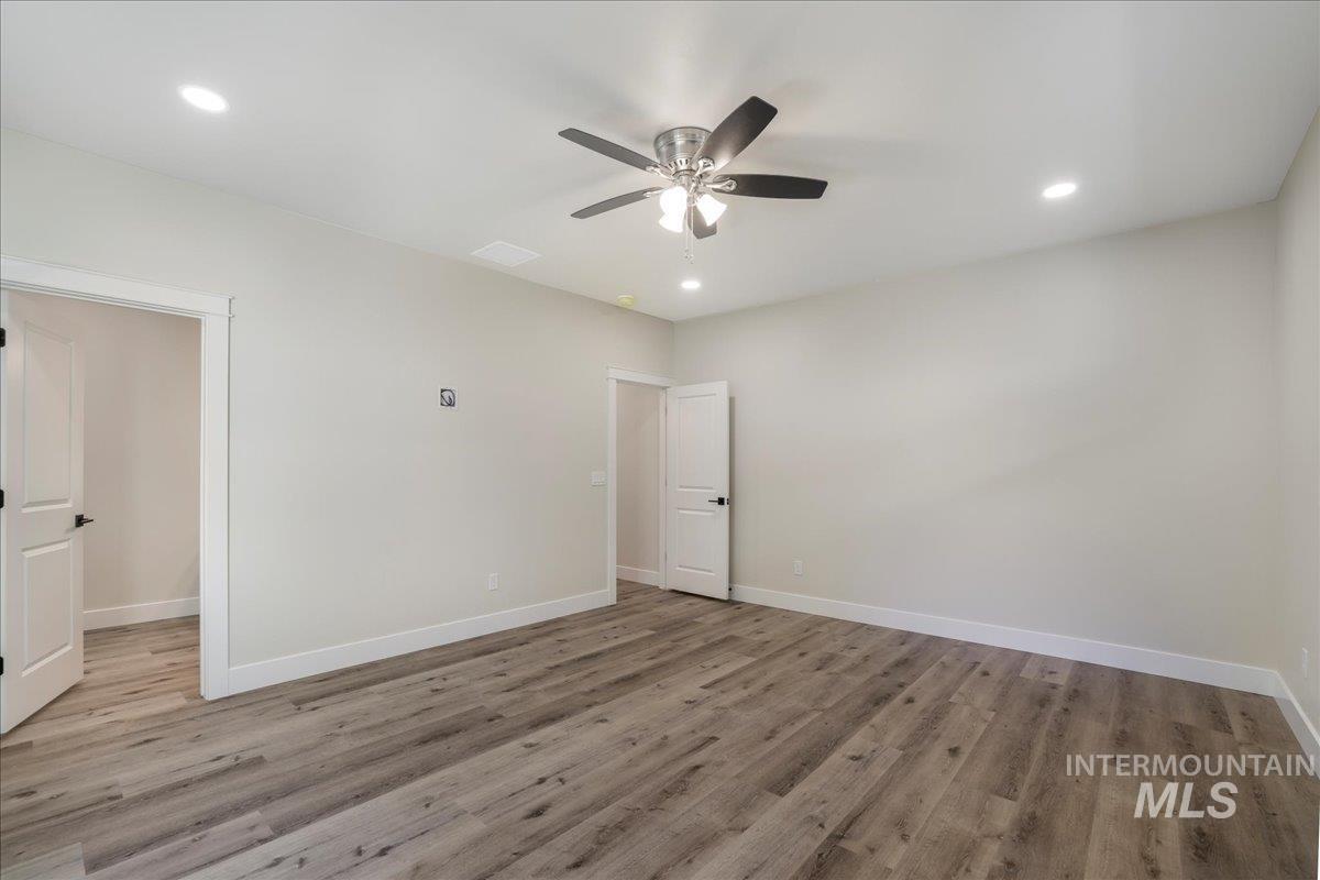 Unfurnished bedroom with light wood-style floors, recessed lighting, and ceiling fan
