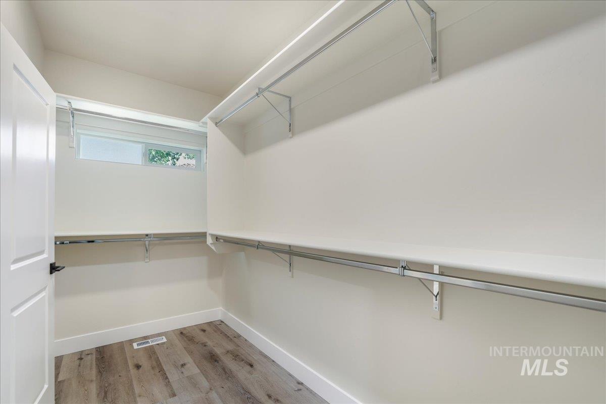 Walk in closet featuring light wood-style flooring