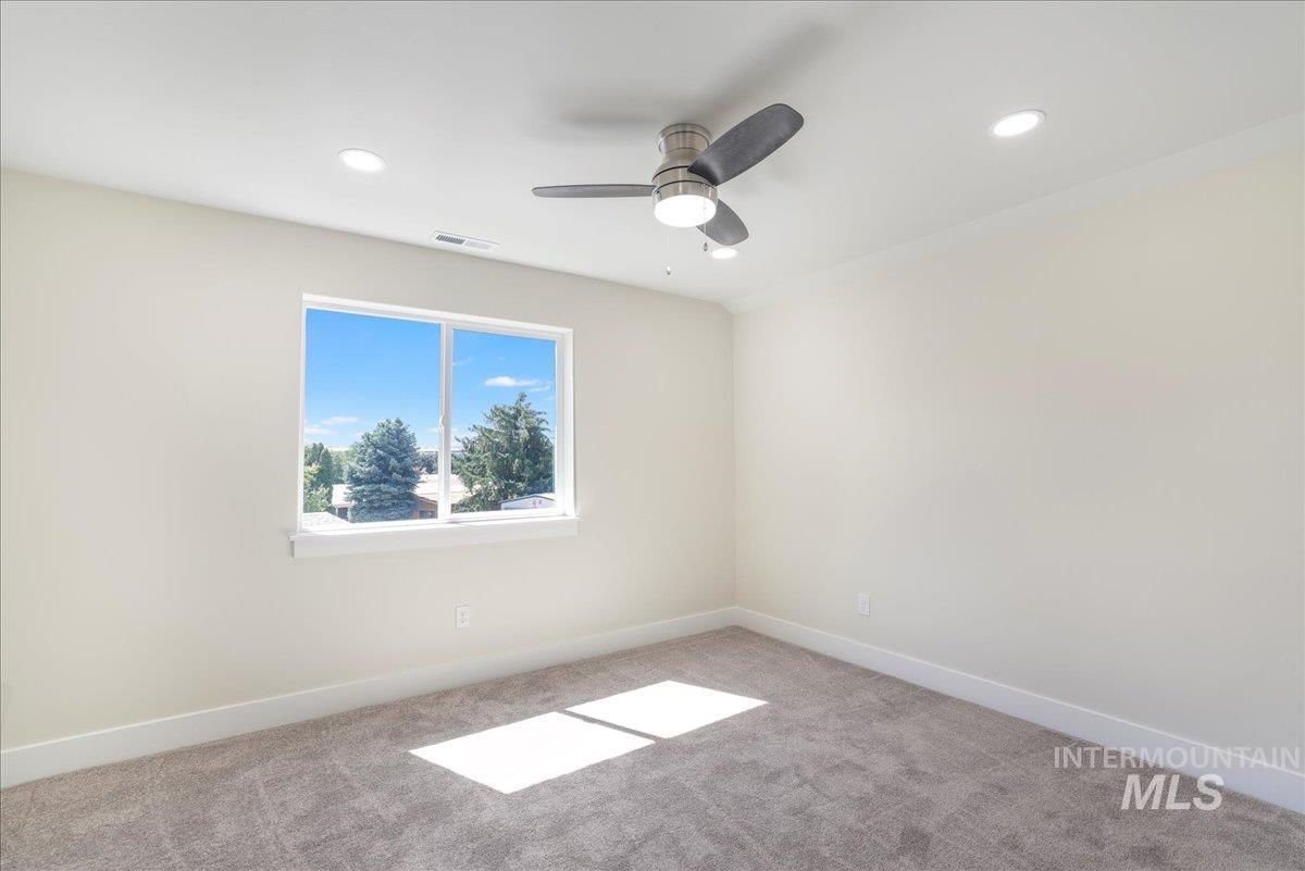 Carpeted spare room featuring recessed lighting and ceiling fan
