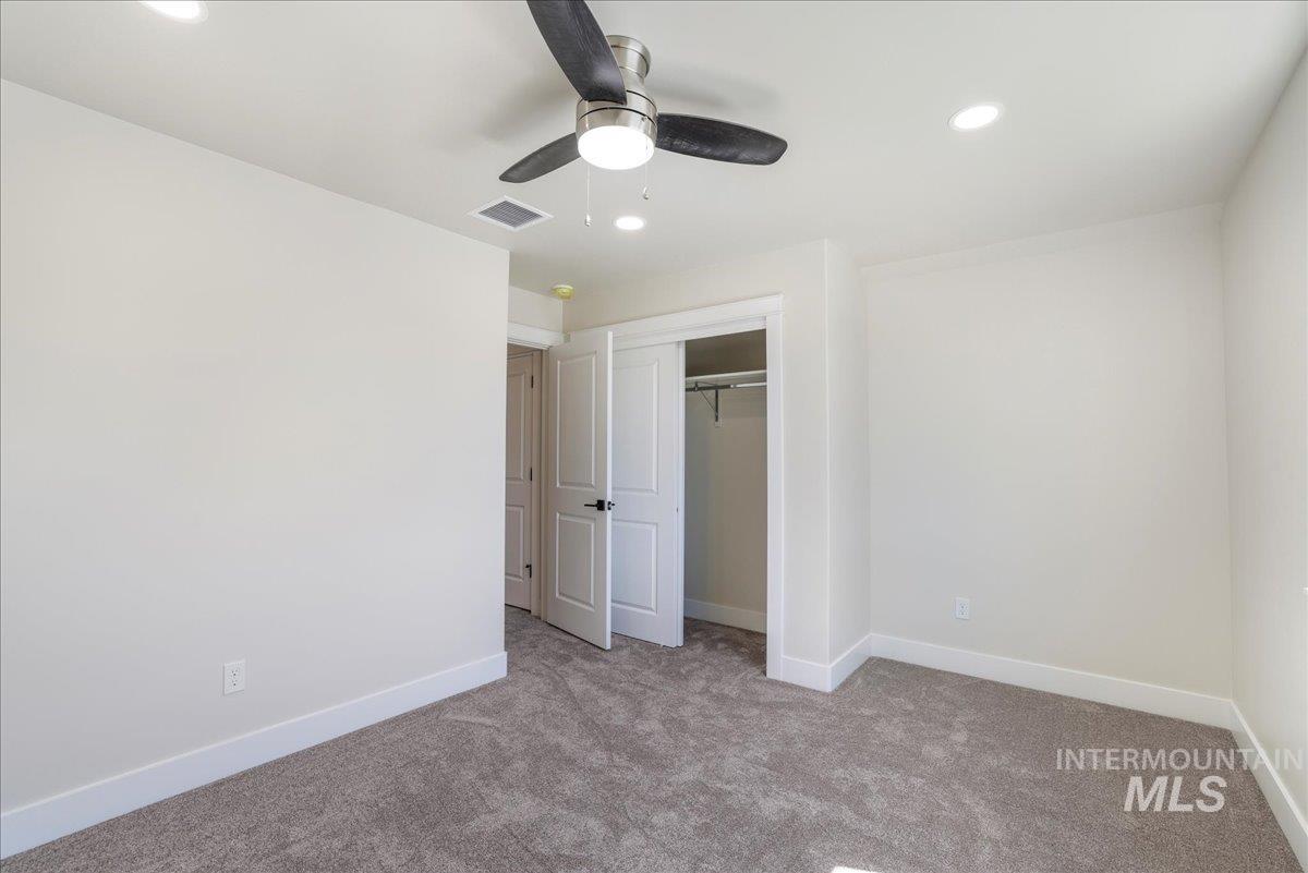 Unfurnished bedroom with carpet floors, recessed lighting, a closet, and ceiling fan