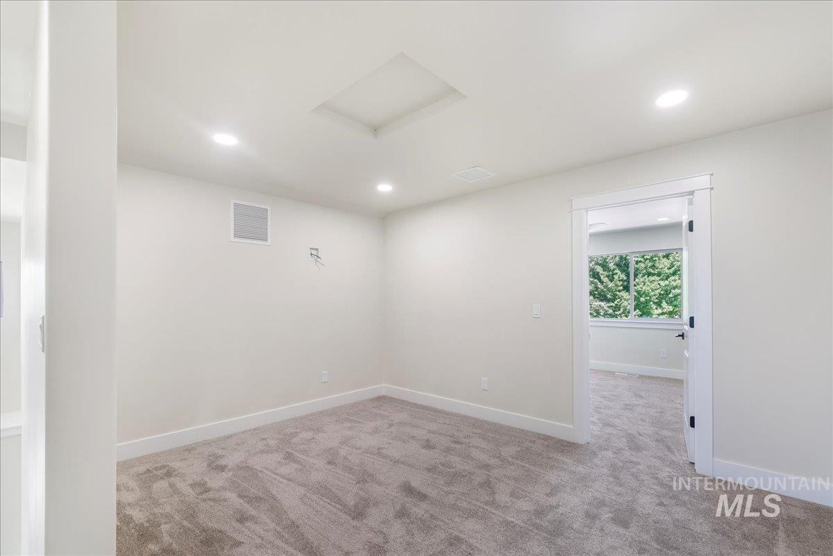 Unfurnished room featuring attic access, light carpet, and recessed lighting