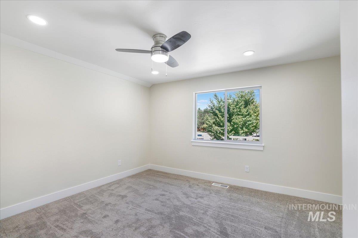 Empty room featuring light colored carpet, recessed lighting, a ceiling fan, and ornamental molding