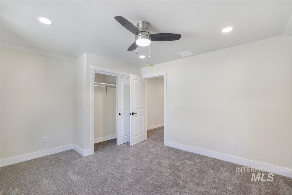 Unfurnished bedroom with carpet flooring, recessed lighting, a ceiling fan, and a closet